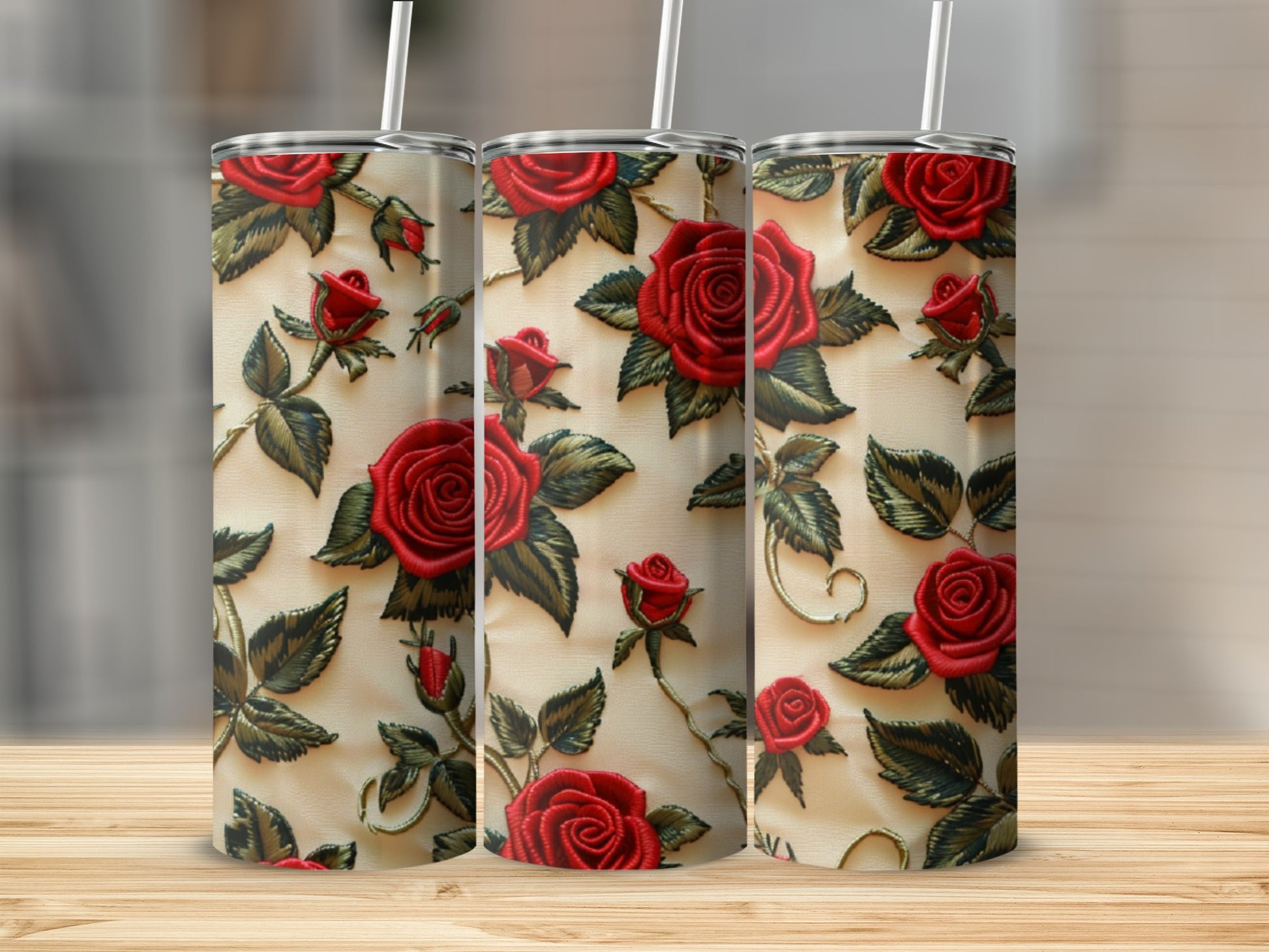 Three tumblers with a red rose and green leaf pattern.