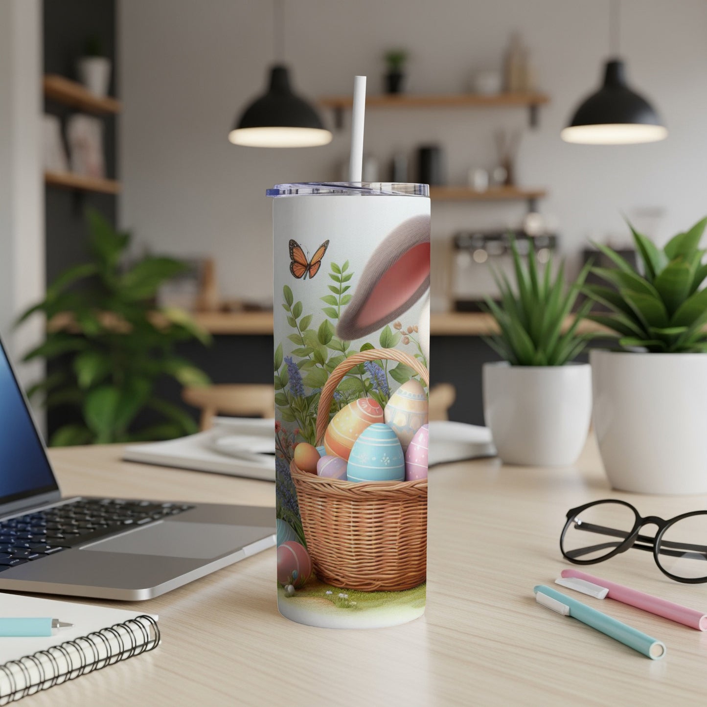 Easter basket with colorful eggs and bunny ears on a desk.