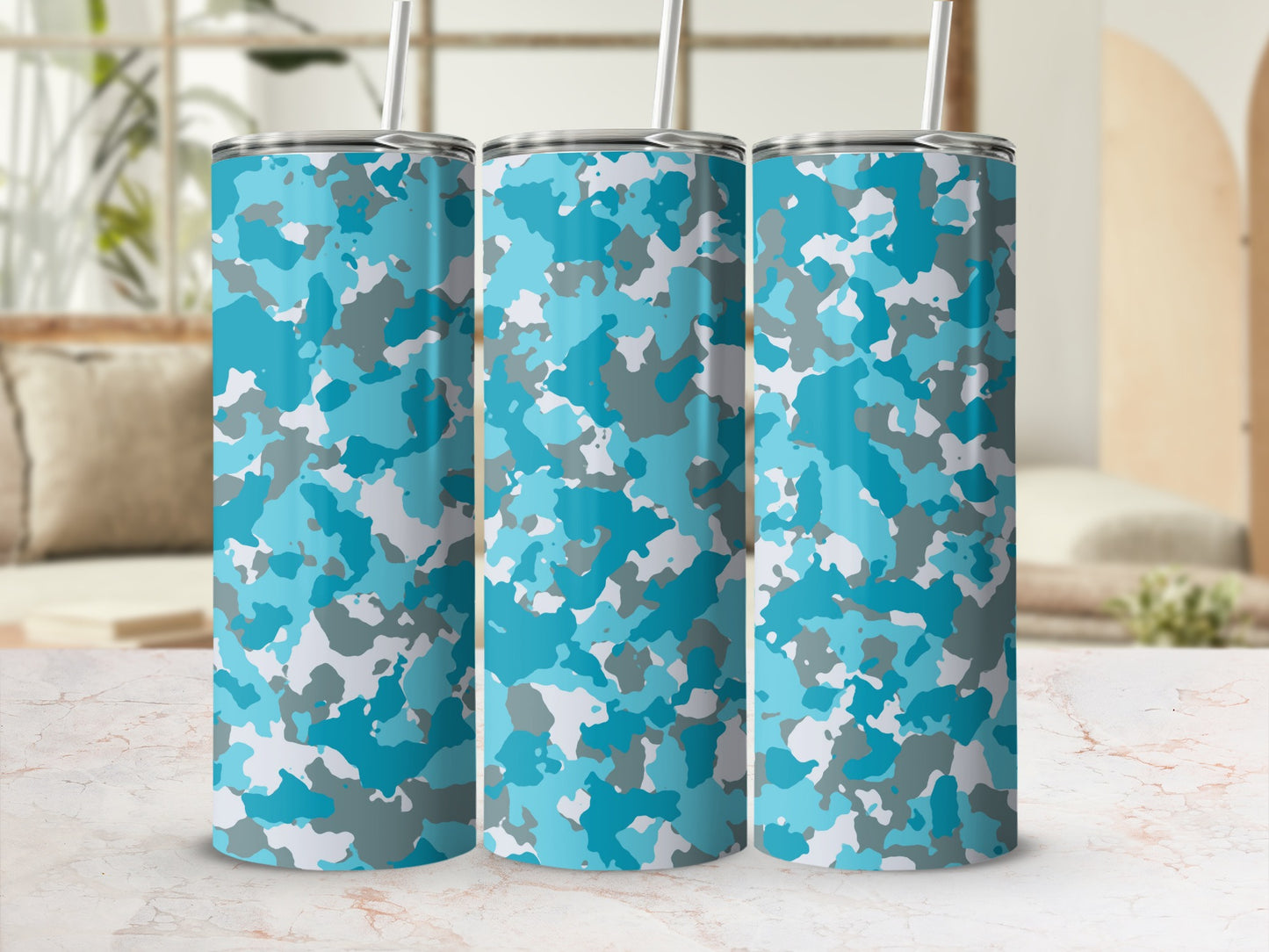 Three tumblers with a blue and gray camouflage pattern and straws.