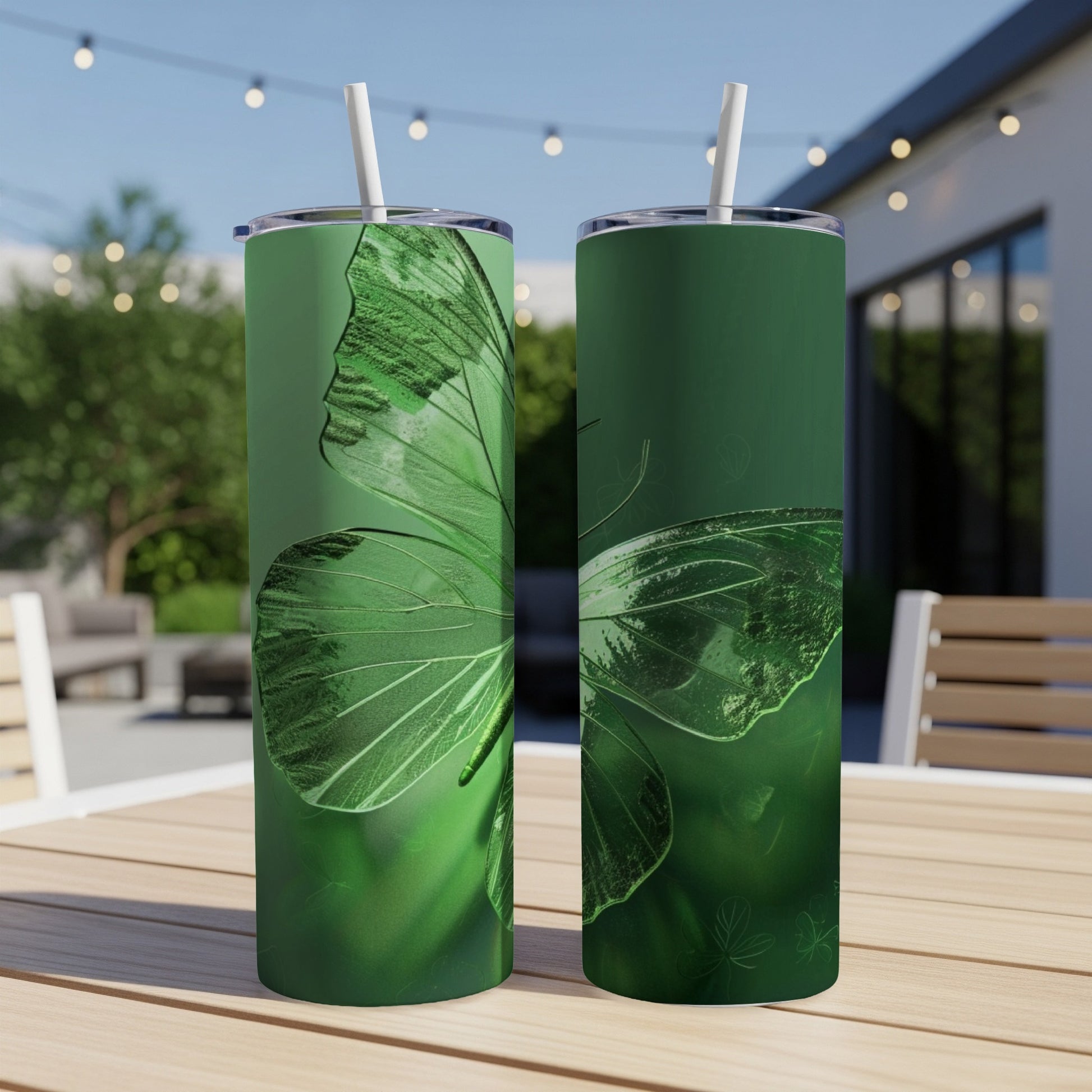 Two green tumblers with a large butterfly wing design.
