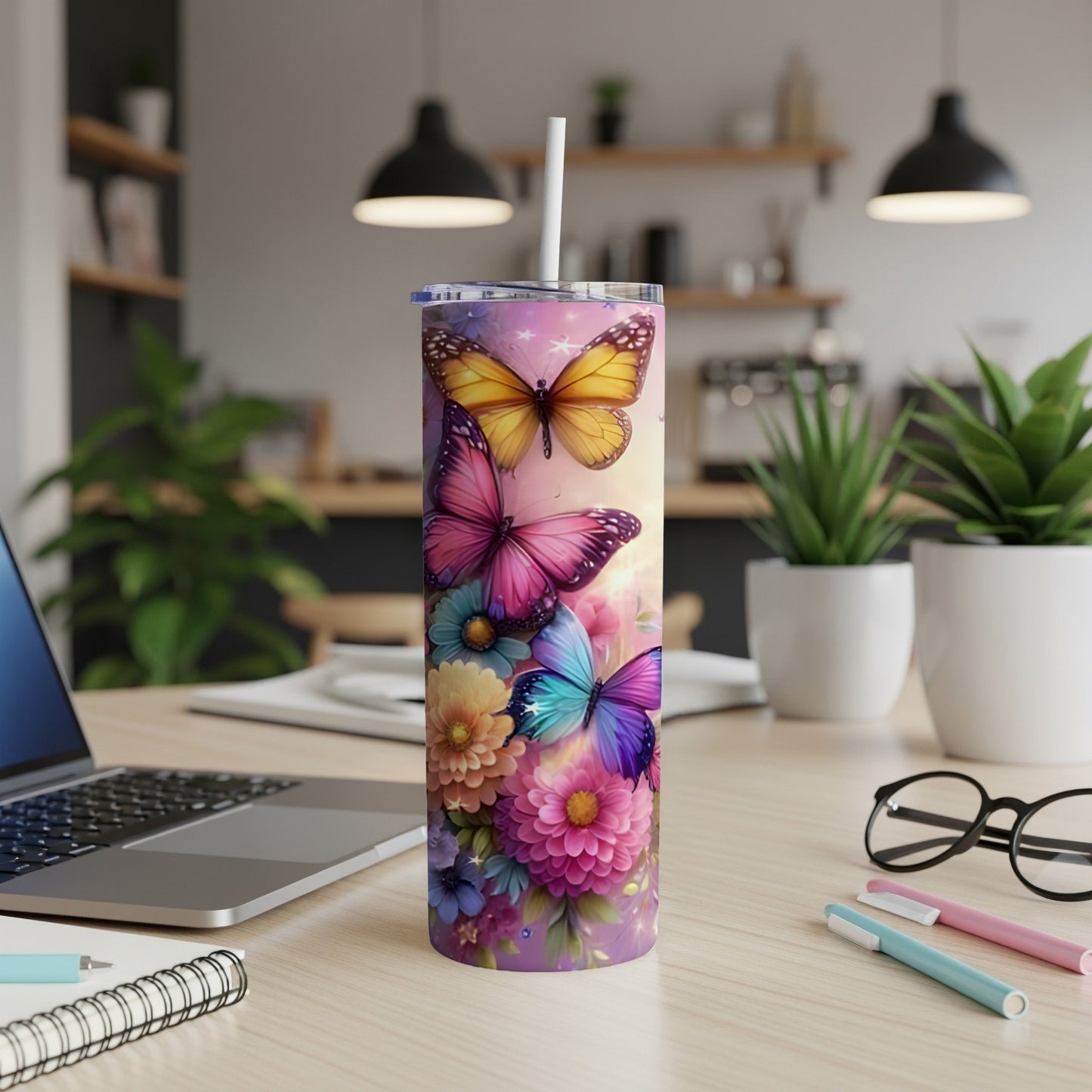Purple, pink, and blue butterflies on a floral pattern tumbler with a straw.