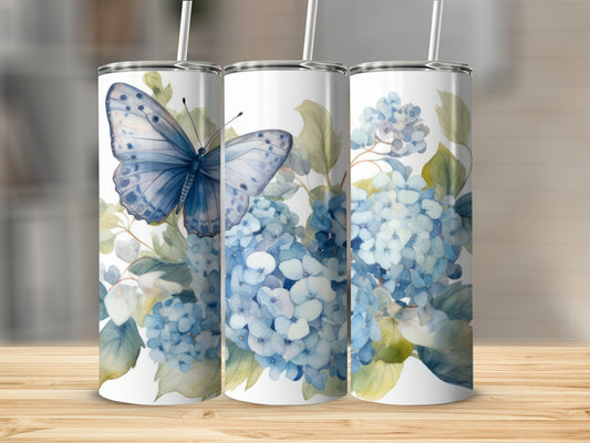 Three tumblers with blue butterflies and hydrangeas on a wooden surface.