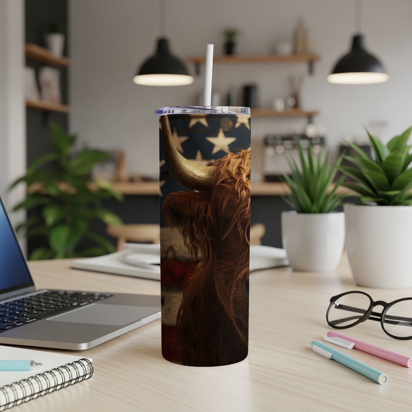 Highland cow with American flag on a tumbler with a straw.