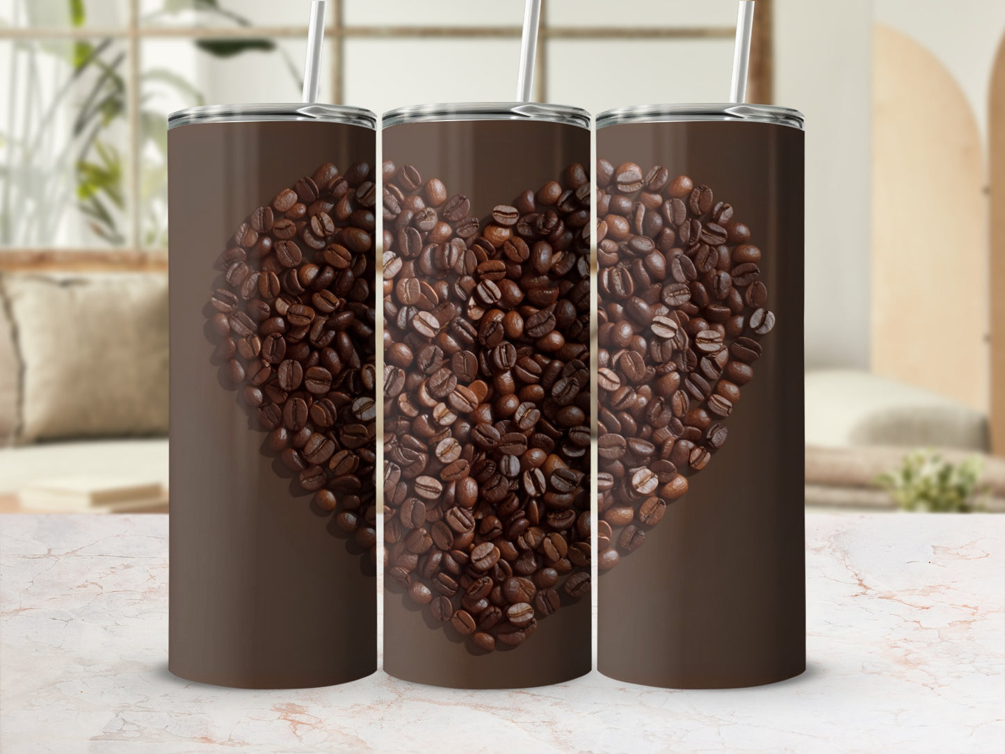 Three coffee tumblers with a heart made of coffee beans on a marble surface.