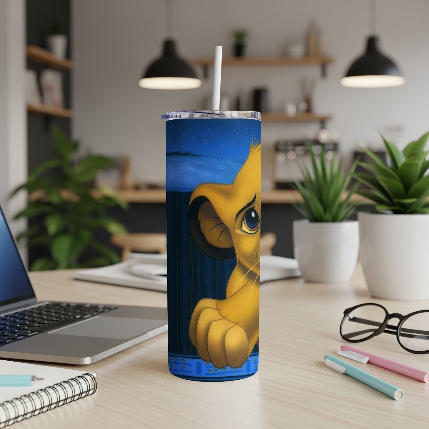 Simba from The Lion King on a blue and gold patterned tumbler.