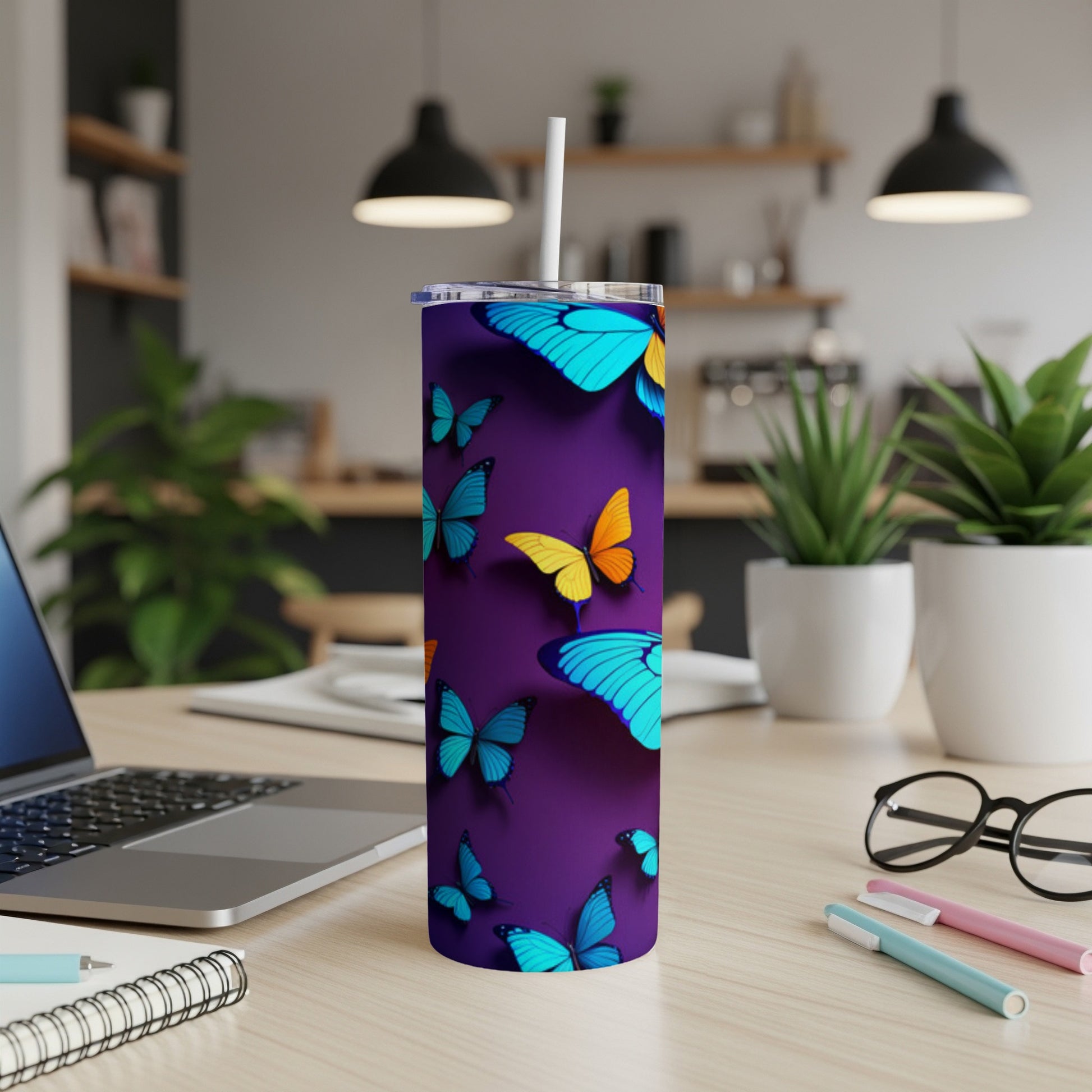 Purple tumbler with blue and yellow butterflies on a desk.