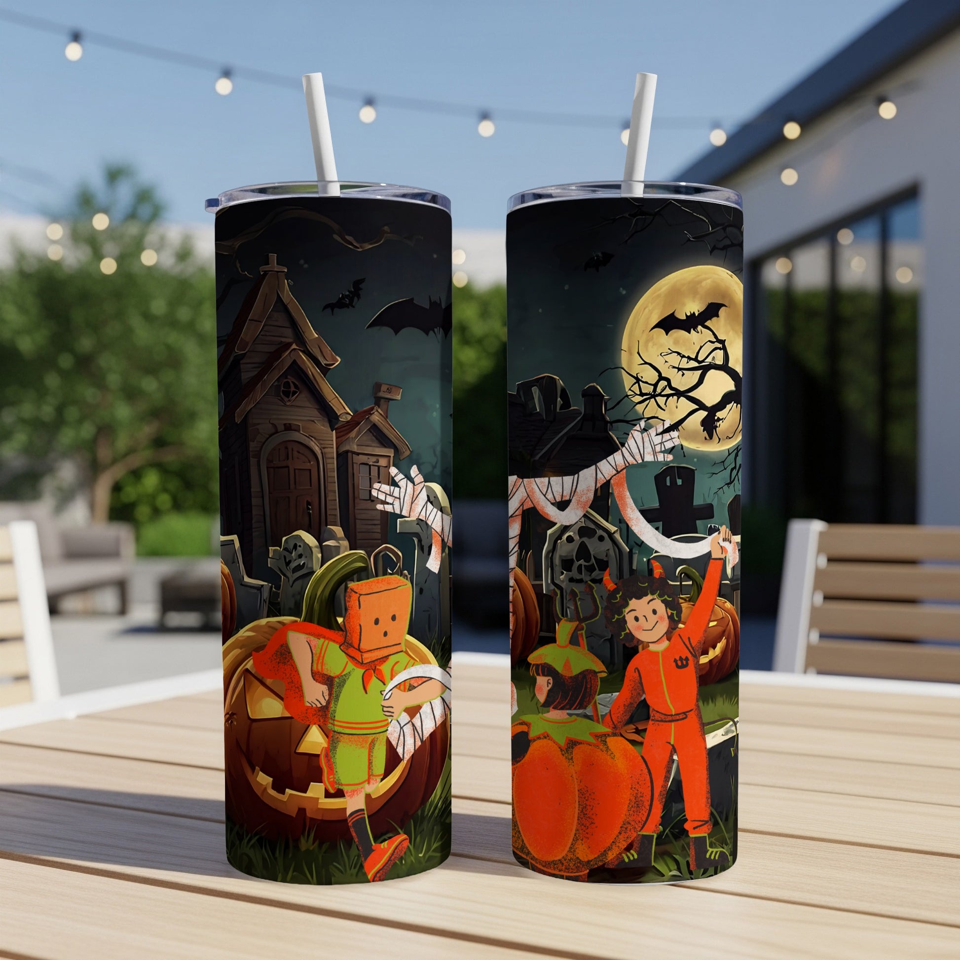 Two Halloween tumblers with spooky cartoon designs of children and pumpkins under a full moon.