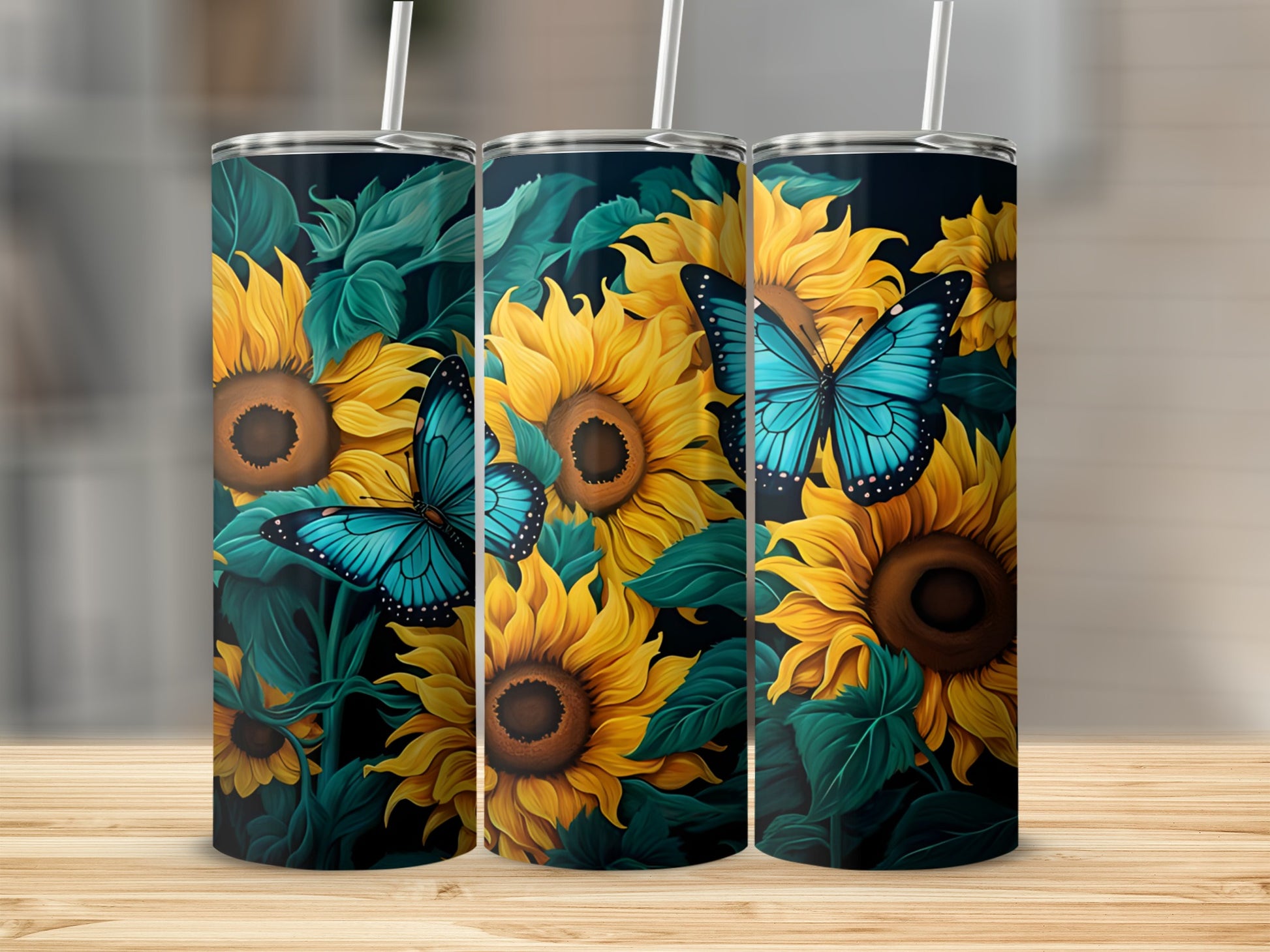 Three tumblers featuring sunflowers and blue butterflies on a dark background.