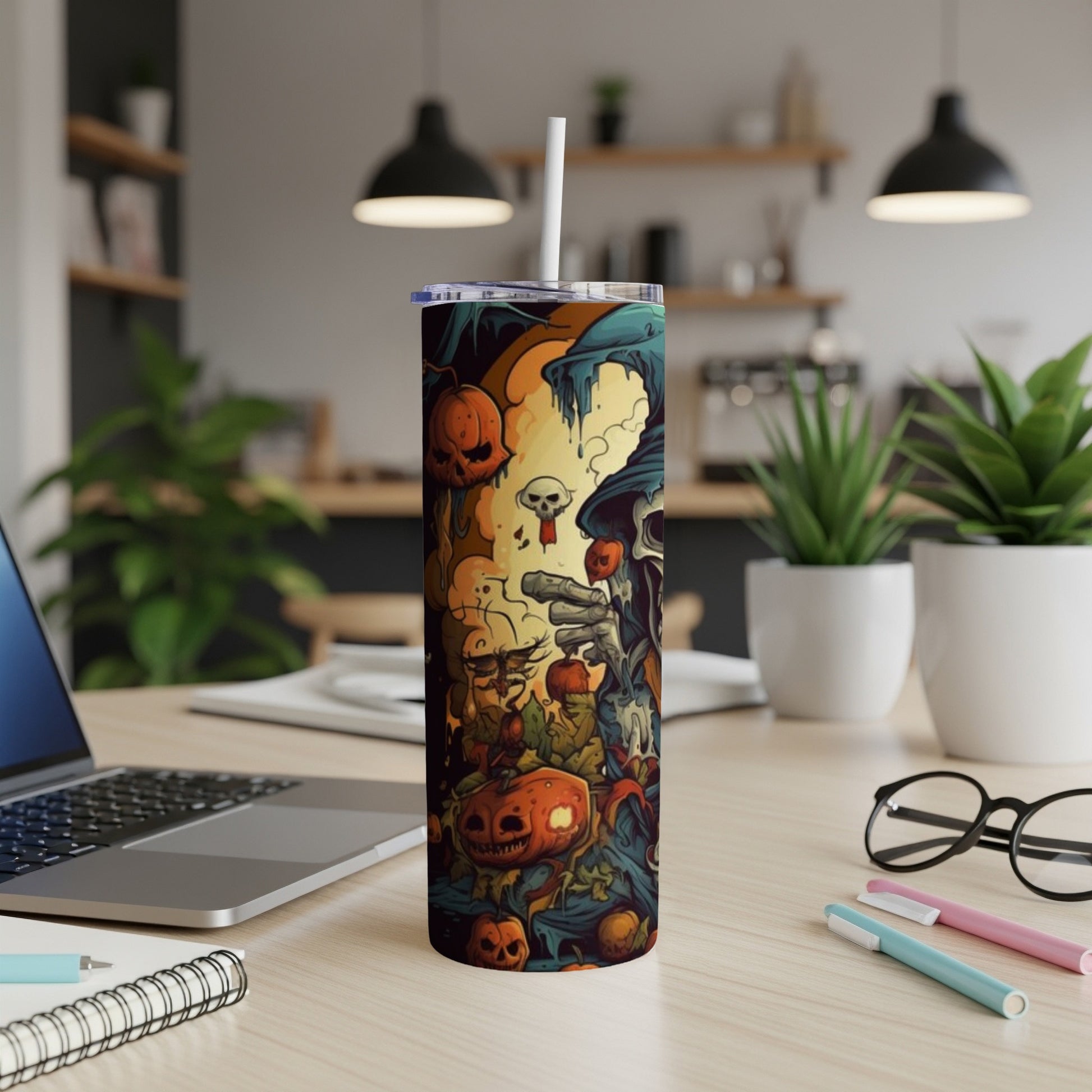 Halloween themed tumbler with pumpkins, skulls, and a grim reaper illustration.