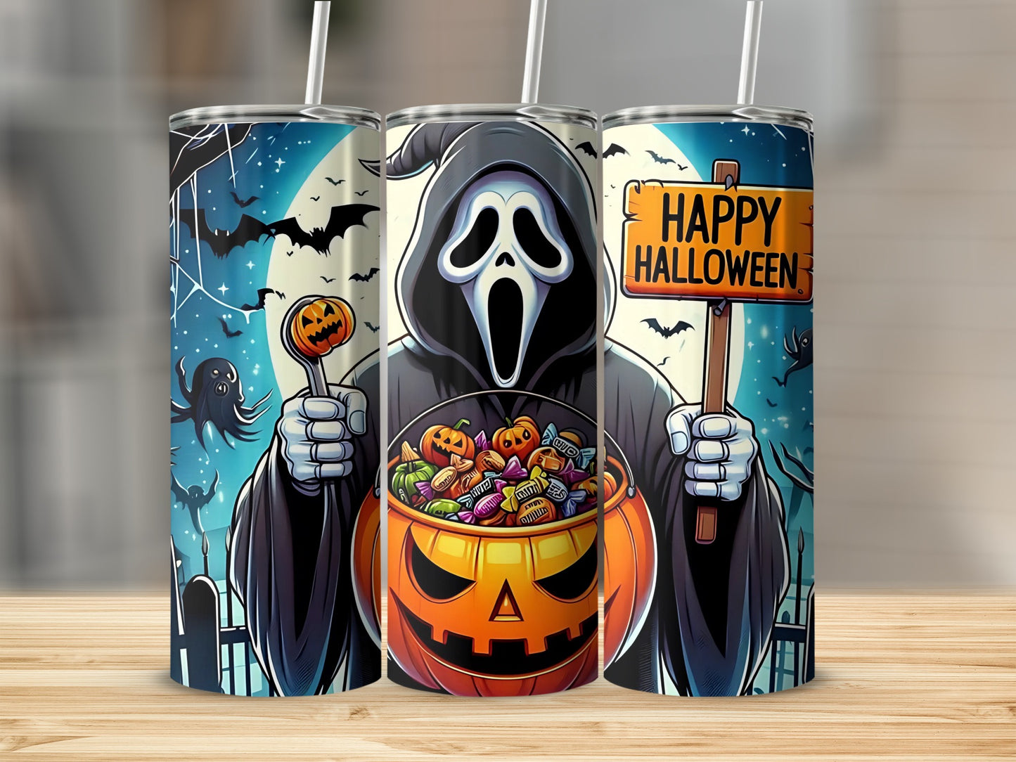 Three tumblers feature a Halloween scene with a ghost holding a pumpkin full of candy.