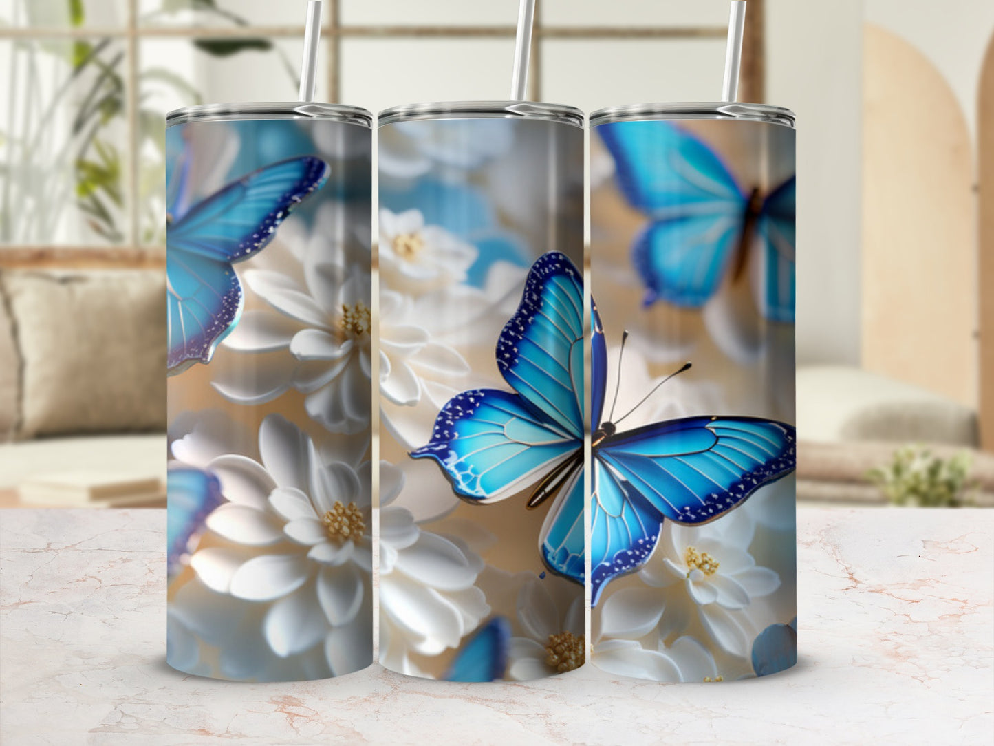 Three tall tumblers with blue butterflies and white flowers.