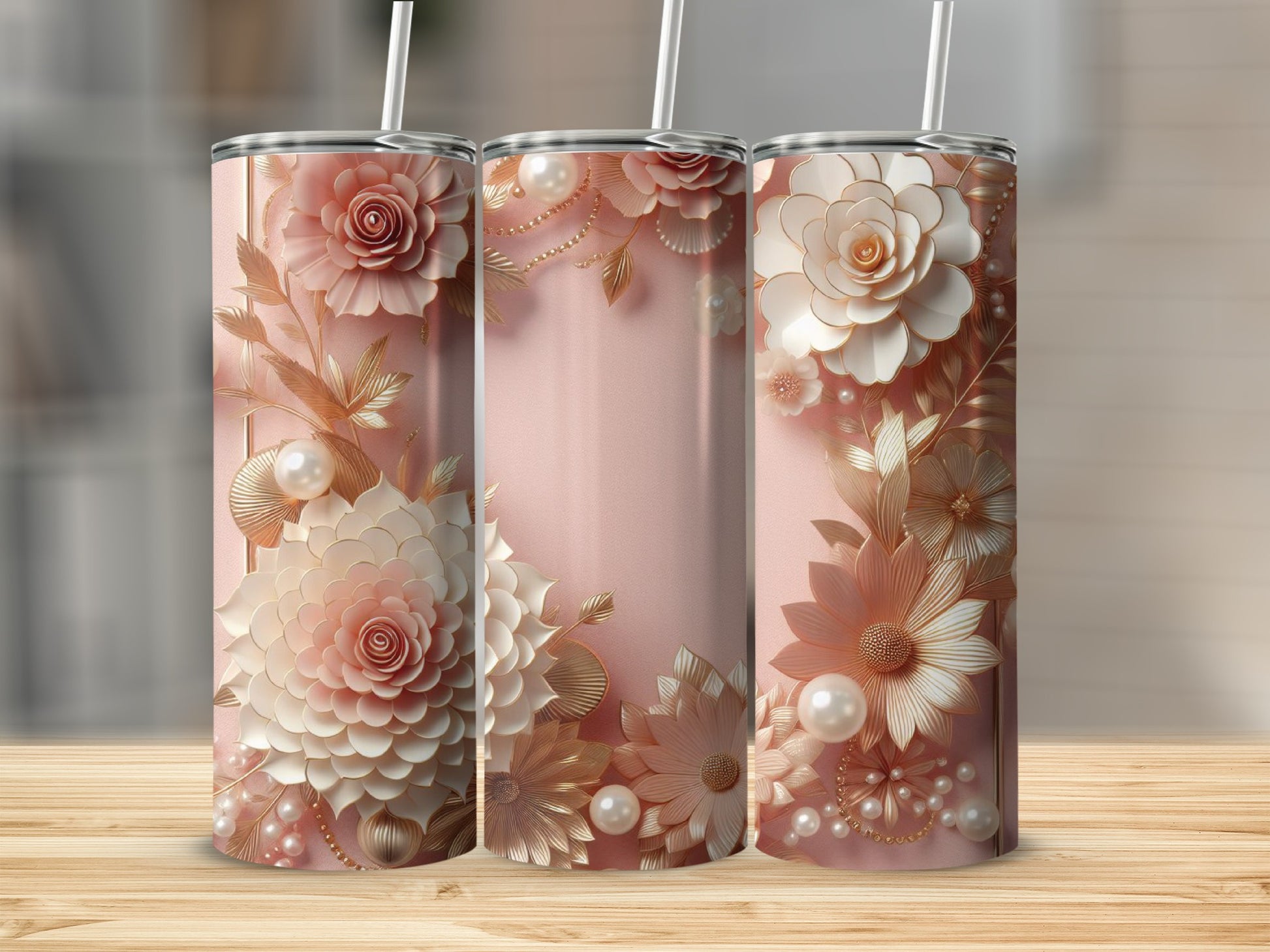 Pink floral tumbler with pearls and gold accents on a wooden surface.