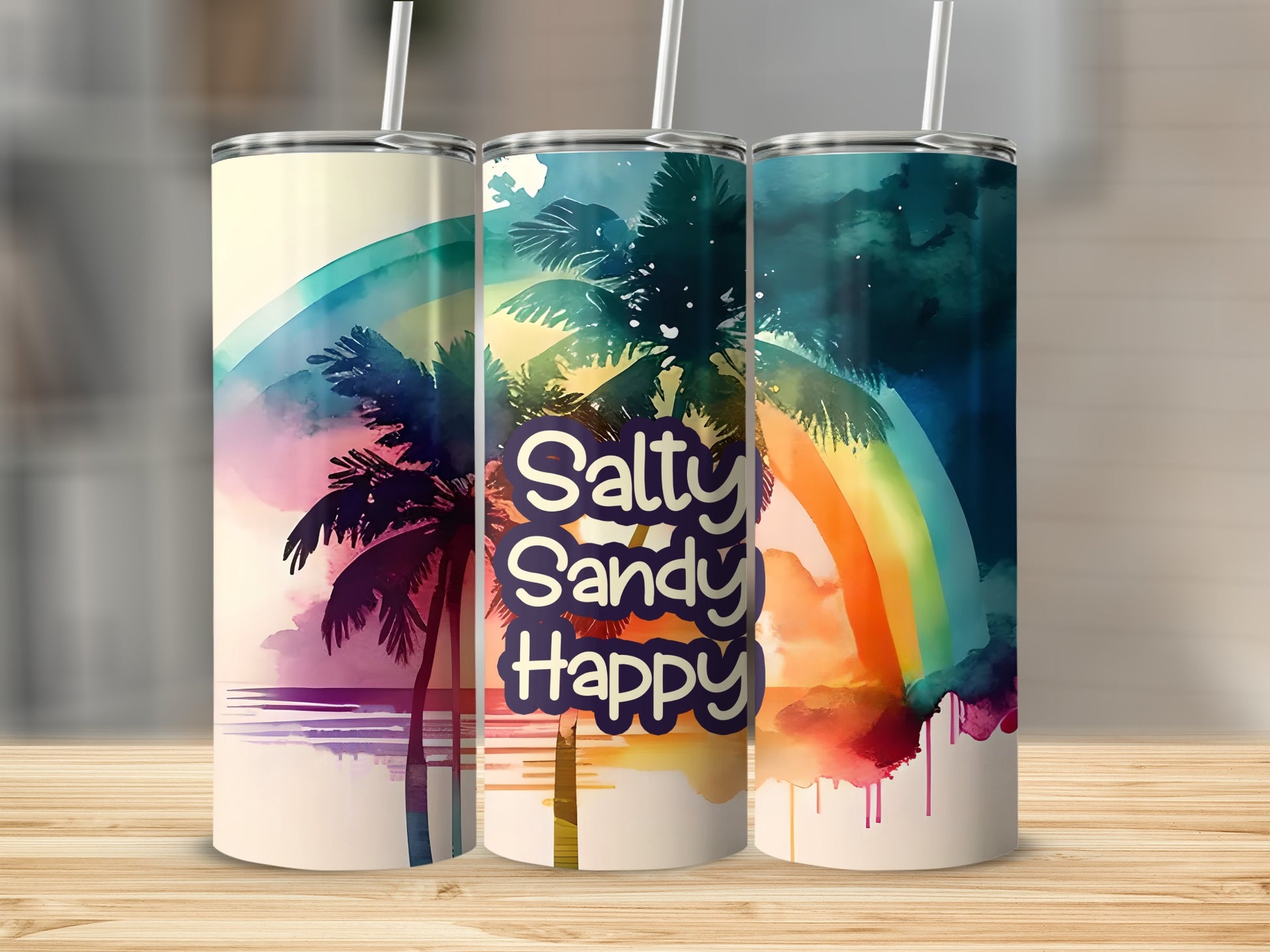 Three tumblers with palm trees and rainbow watercolor designs.
