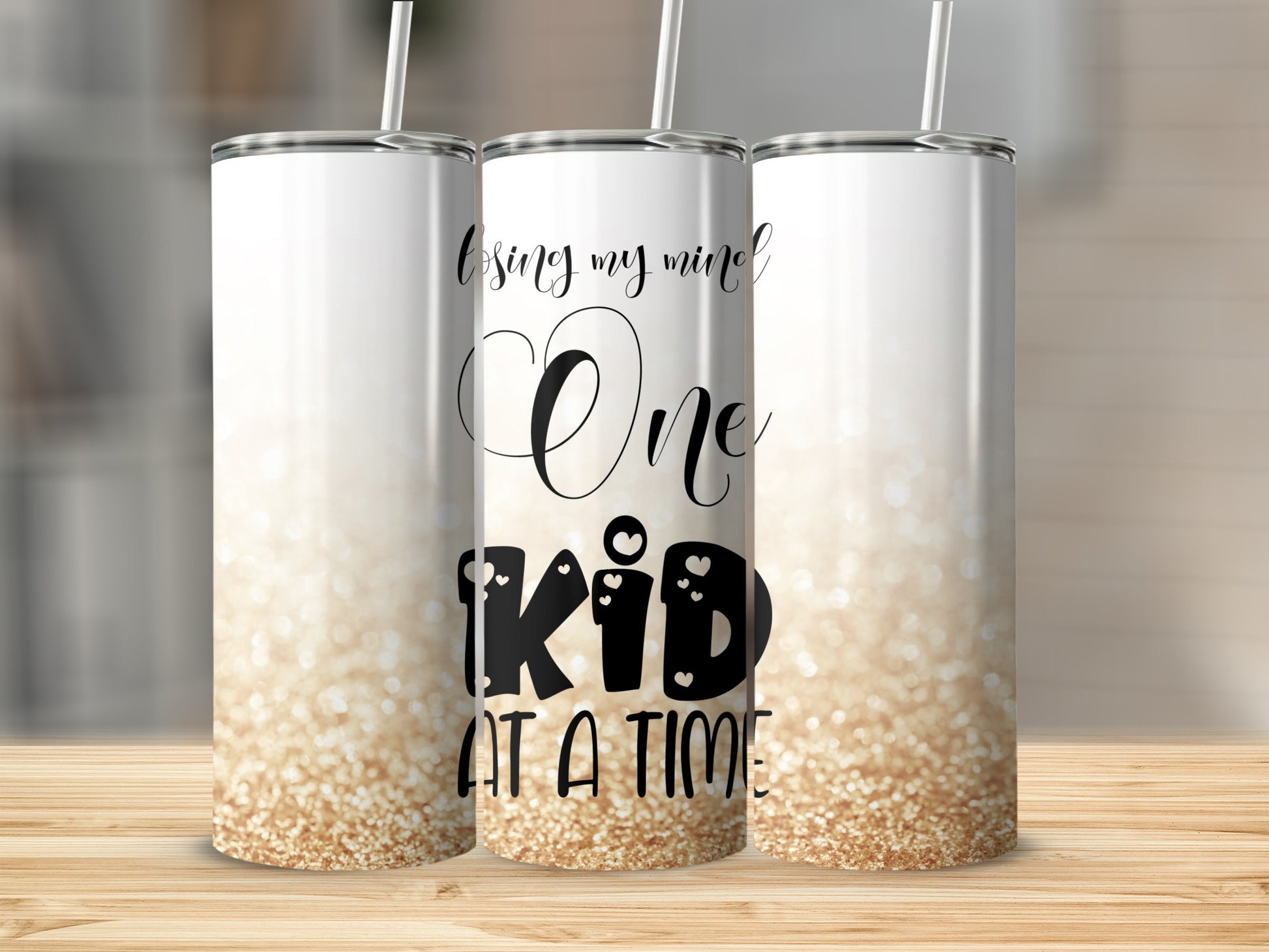 Three tumblers with "Losing my mind One kid AT A TIME" text and glitter.
