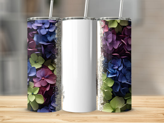 Three tumblers: two with purple, blue, and green floral designs, one blank.