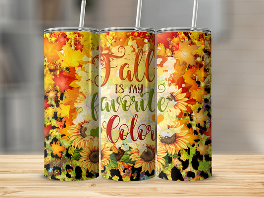 Tumbler with "Fall is my favorite Color" text and sunflowers on a wooden surface.