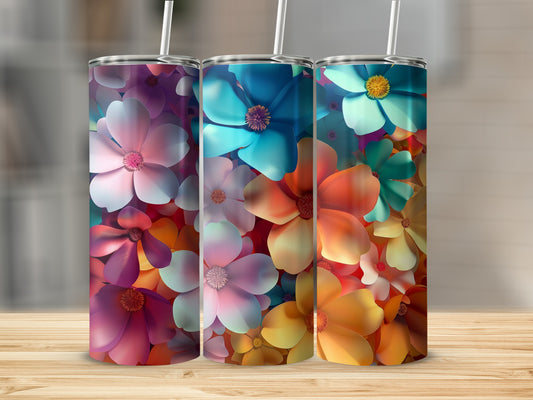 Three tumblers with colorful floral patterns sit on a wooden surface.