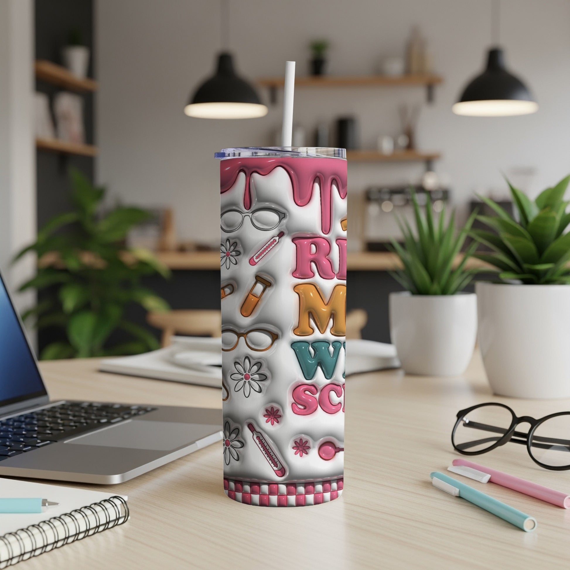 Tumbler with "RN M SCN" text and medical icons on a desk.