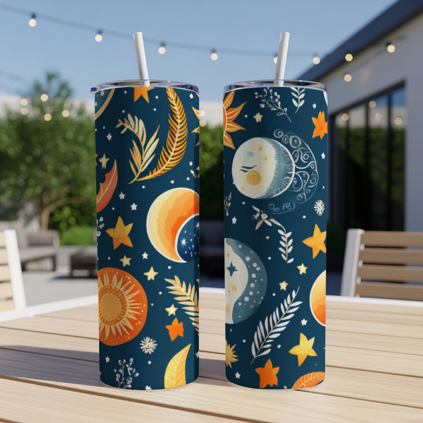 Two dark blue tumblers with celestial and botanical patterns.