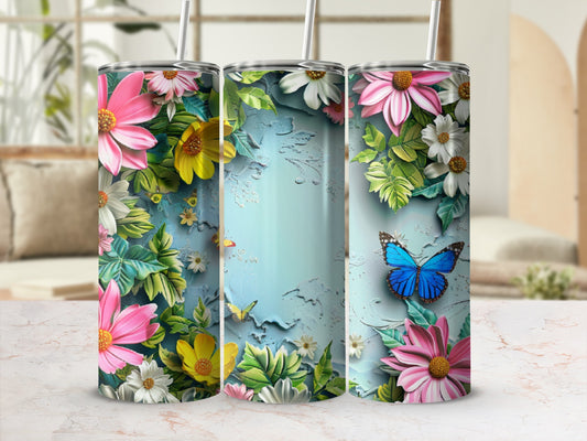 Three tall tumblers with floral and butterfly designs on a marbled surface.