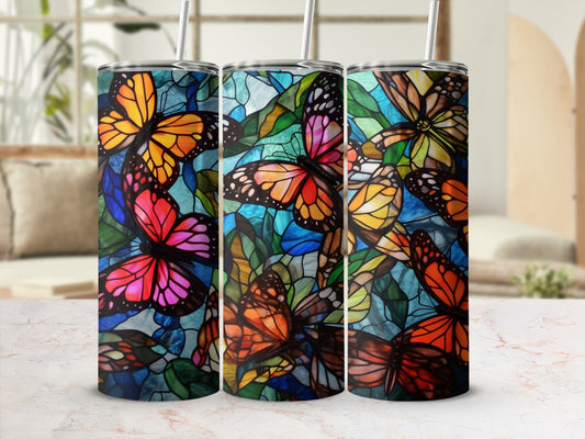 Three tumblers with colorful stained-glass butterfly designs.