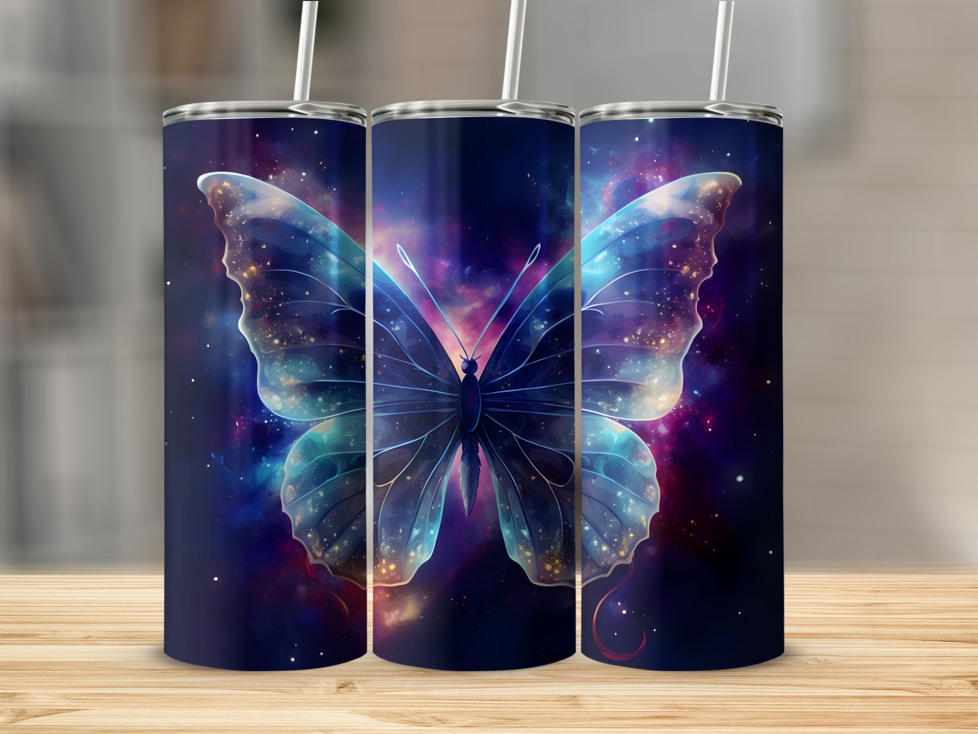 Three tumblers with a glowing blue butterfly and nebula design.