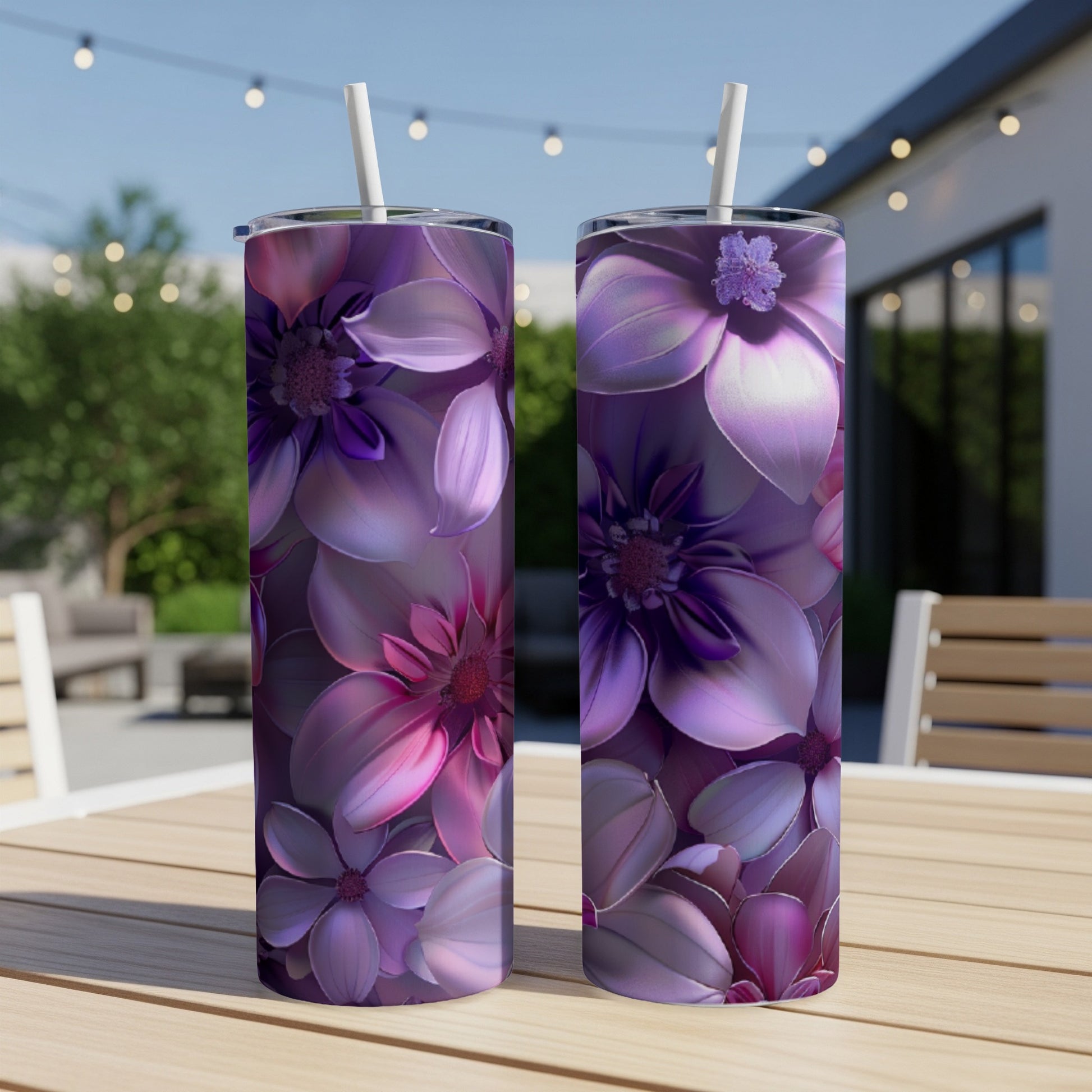 Two purple and pink floral pattern tumblers on a wooden table.
