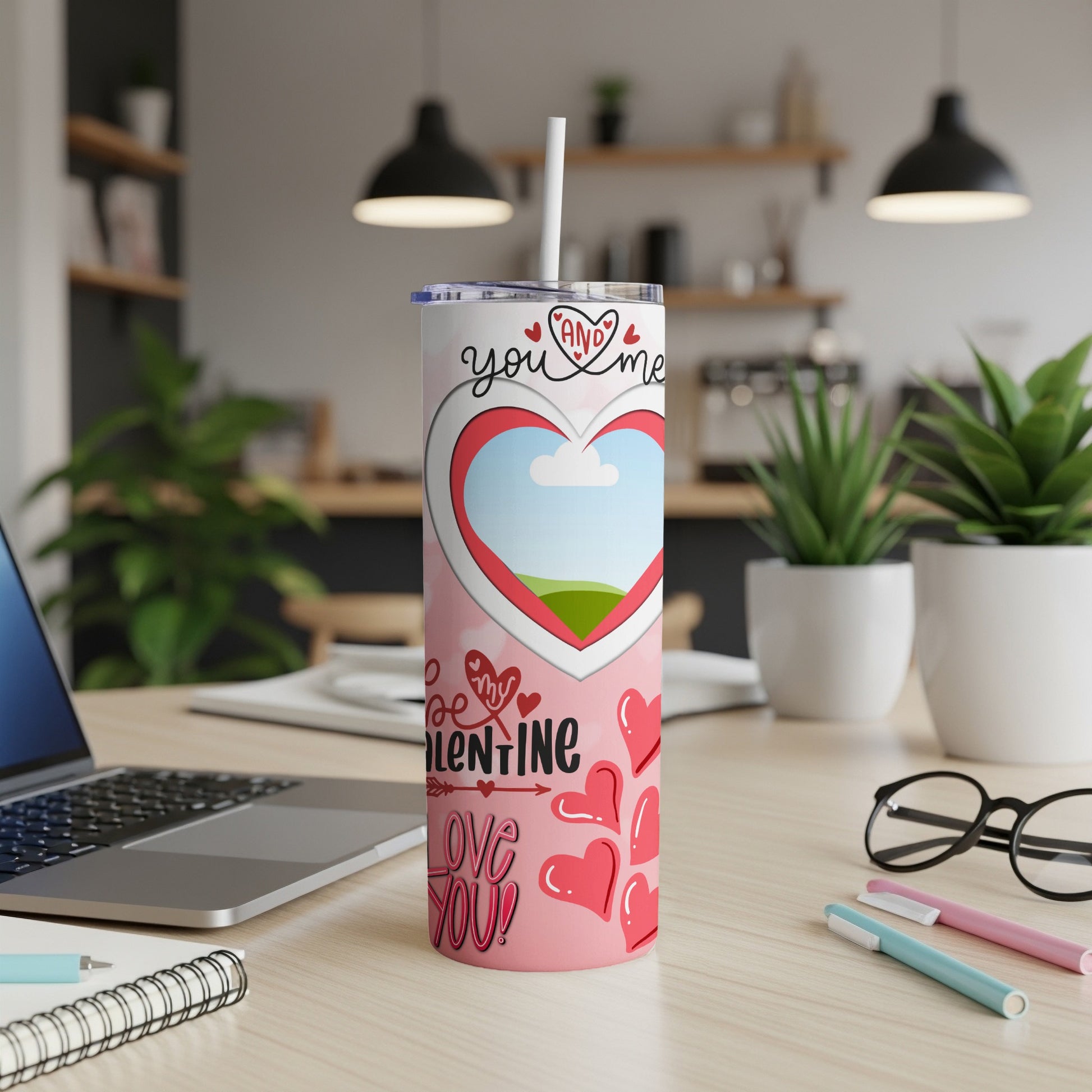 Pink tumbler with Valentine's Day heart design, "you and me," and "love you!" text.