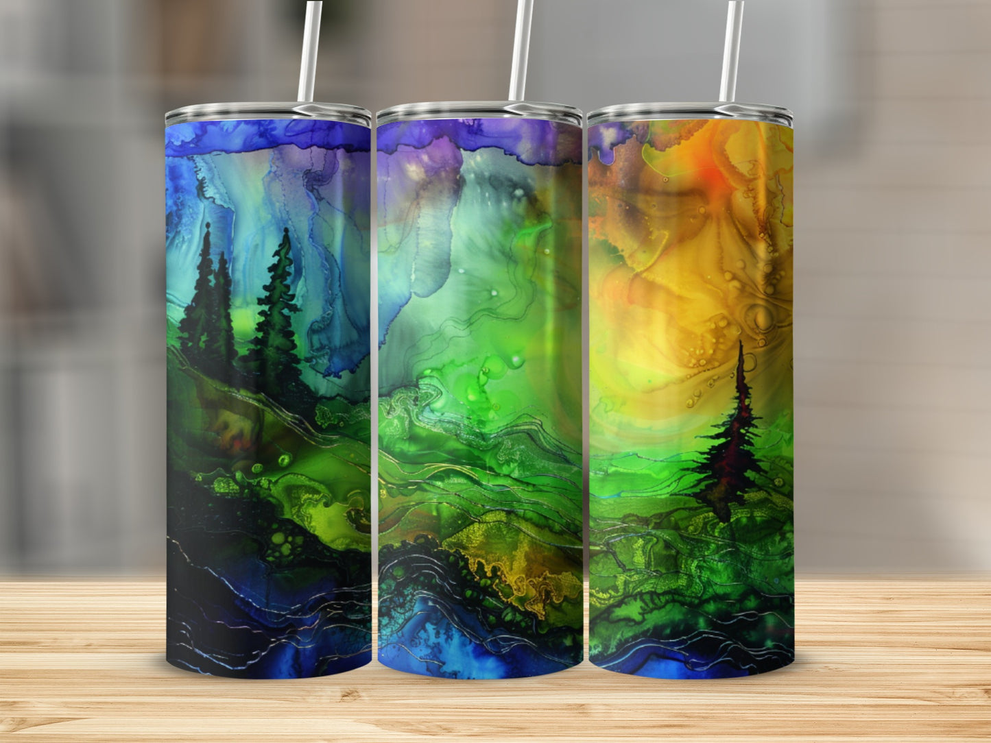 Three tumblers with colorful abstract forest and mountain designs.