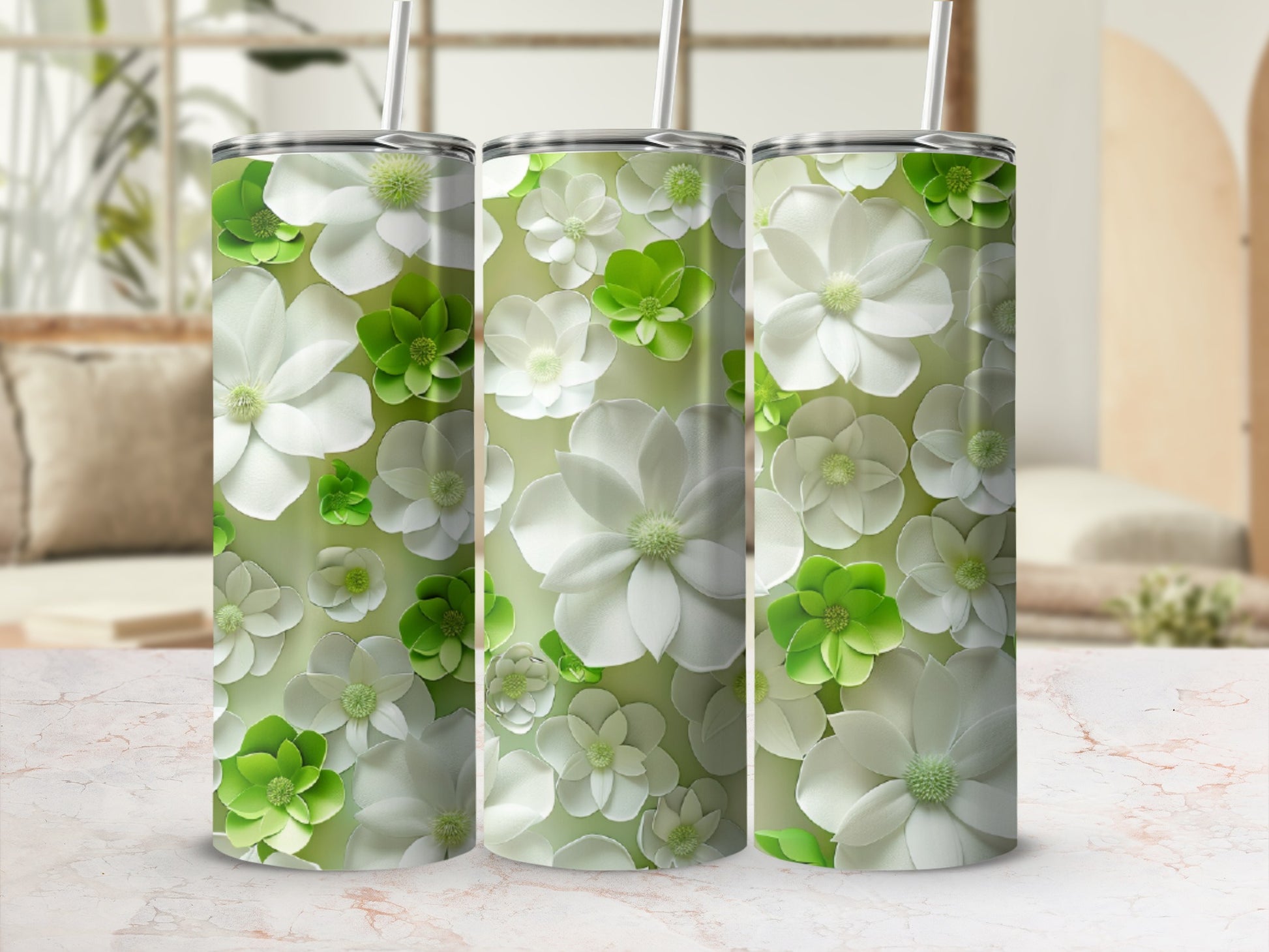 Three tumblers adorned with a pattern of white and green flowers.