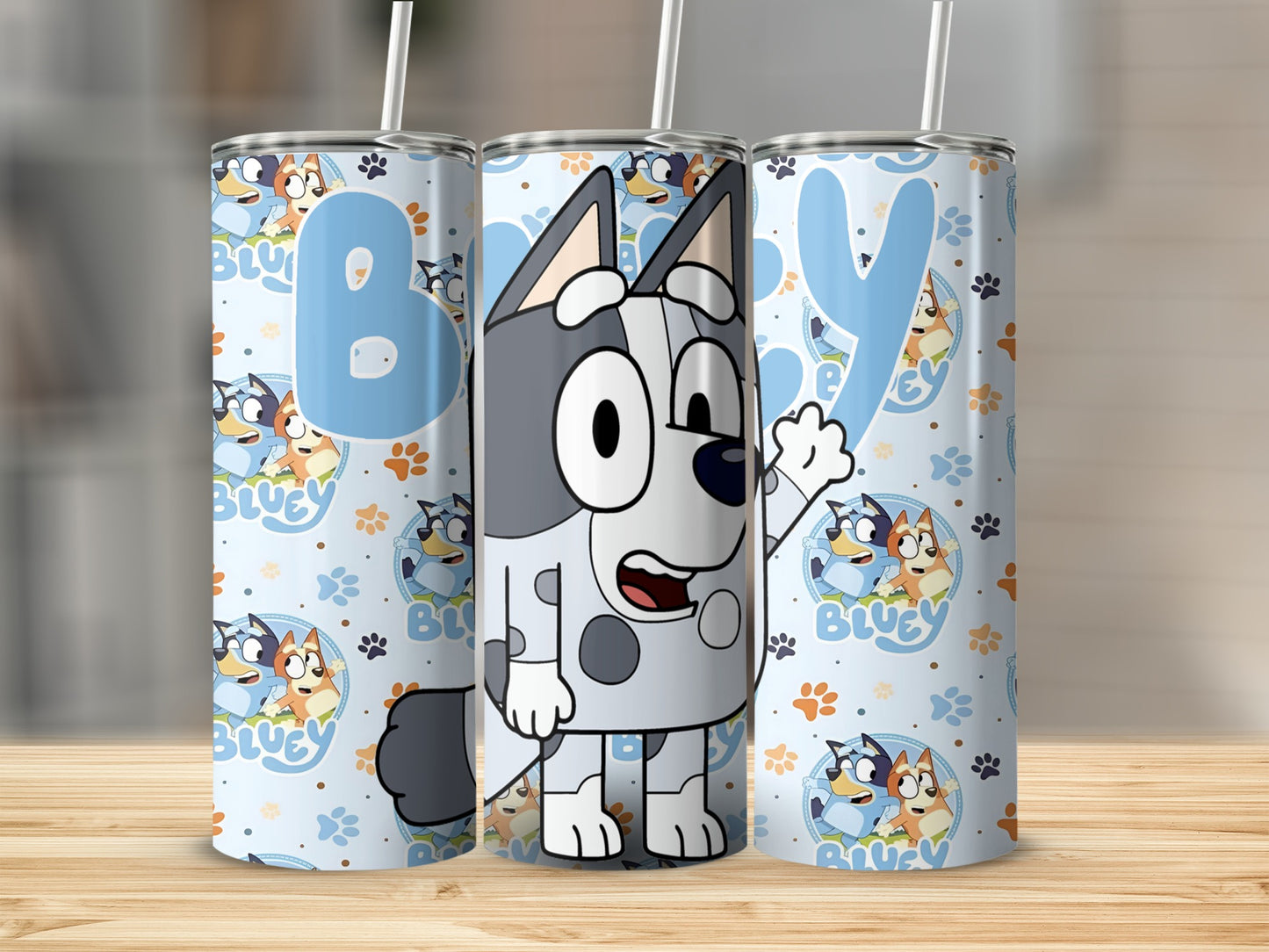 Bluey character tumbler with cartoon Bluey, Bingo, andpaw prints.