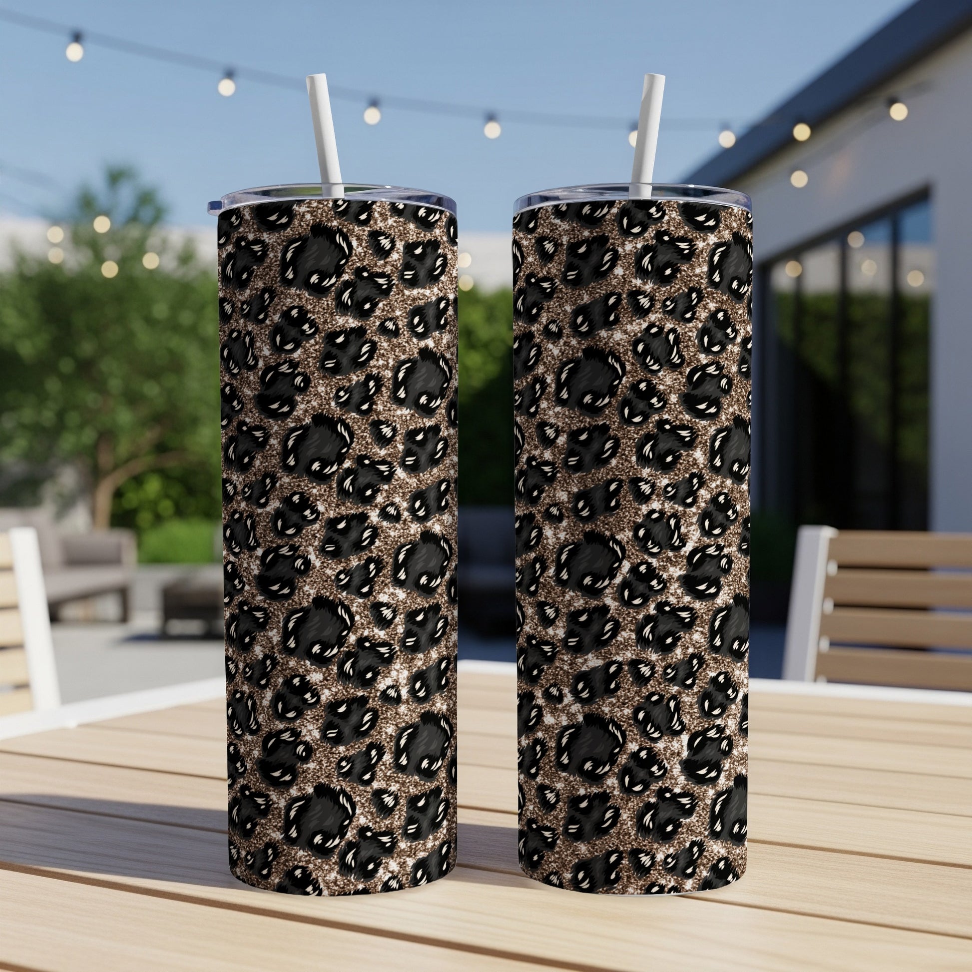 Two tall tumblers with a black and gold leopard print pattern.