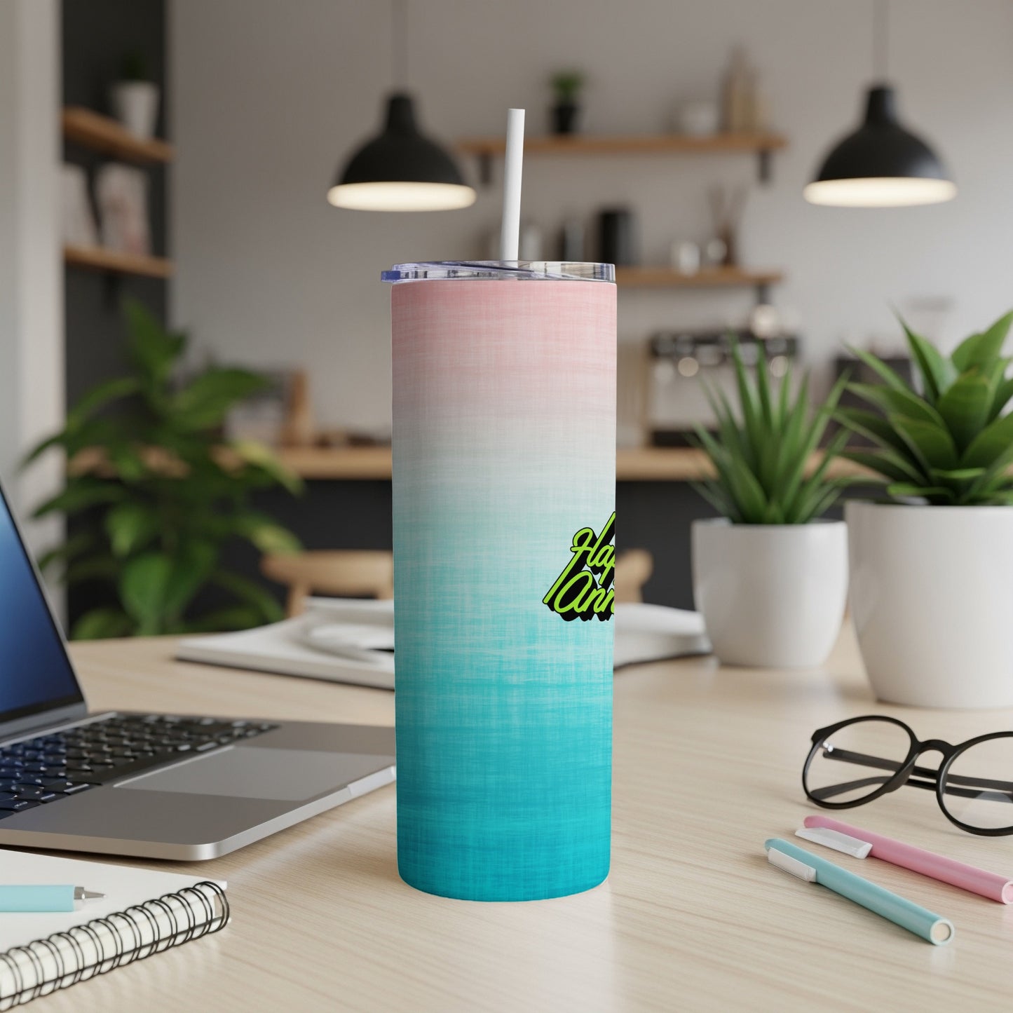 Gradient pink and teal tumbler with "Happy Anniversary" text on a desk.