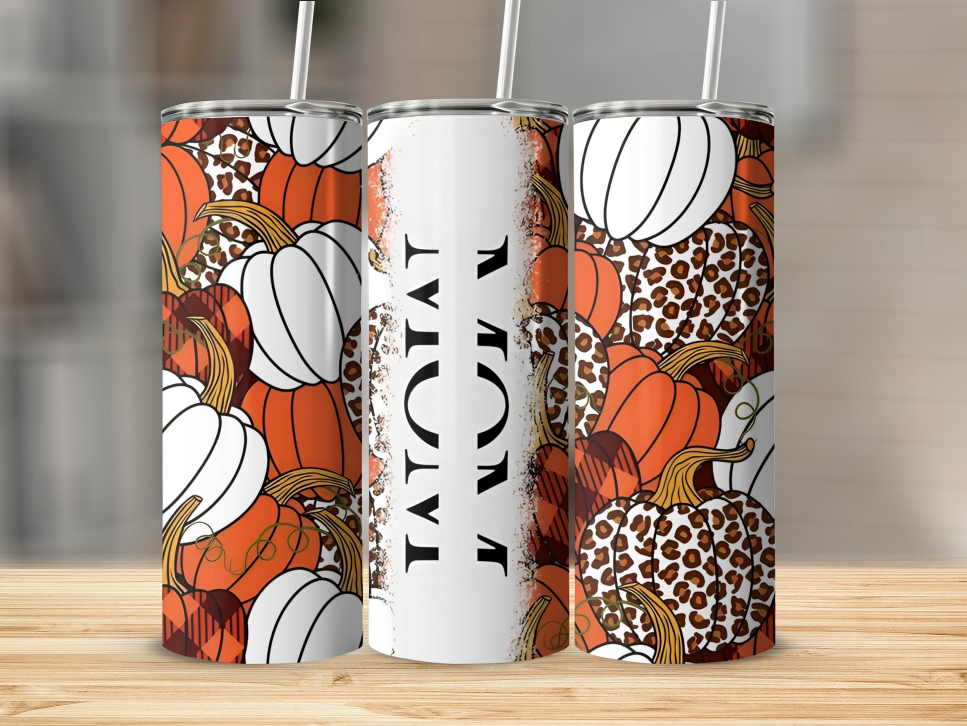 Three tumblers with pumpkin and leopard print designs.