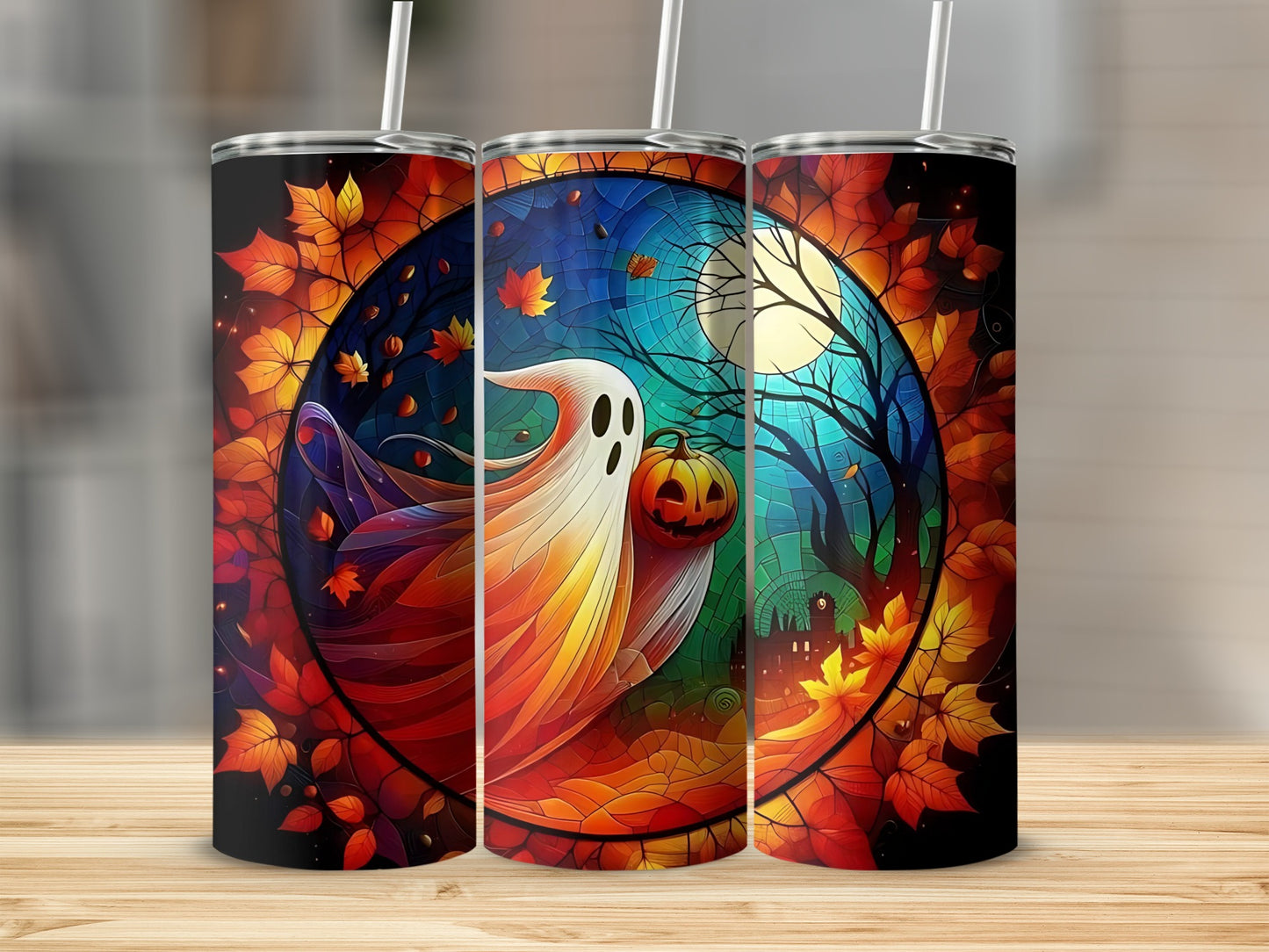 Three tumblers featuring a colorful Halloween scene with a ghost, pumpkin, and moon.