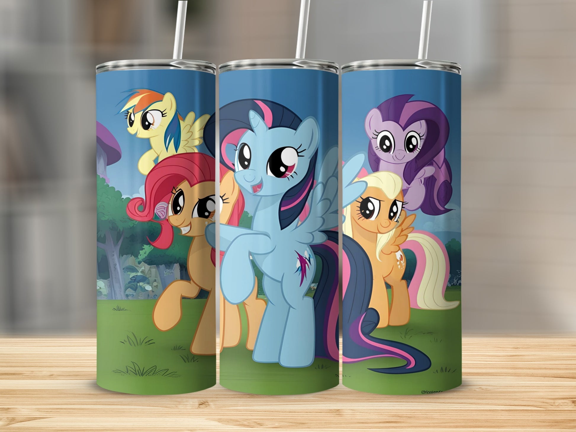 My Little Pony characters Twilight Sparkle, Fluttershy, and Applejack on a blue tumbler.