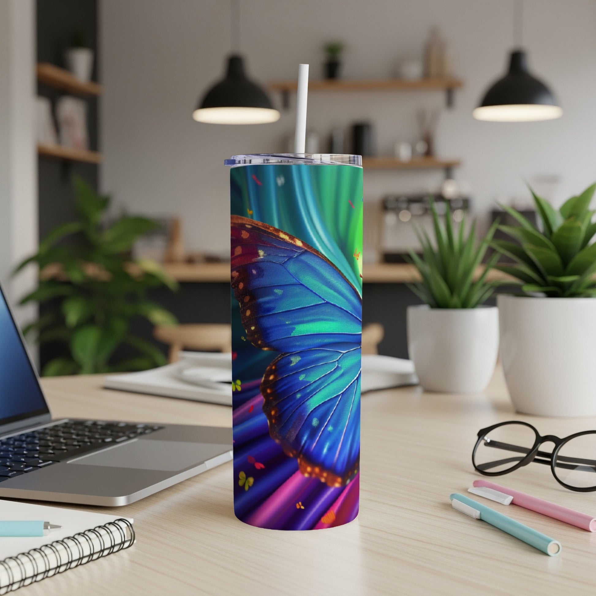 Blue butterfly wings and vibrant abstract background on a skinny tumbler.