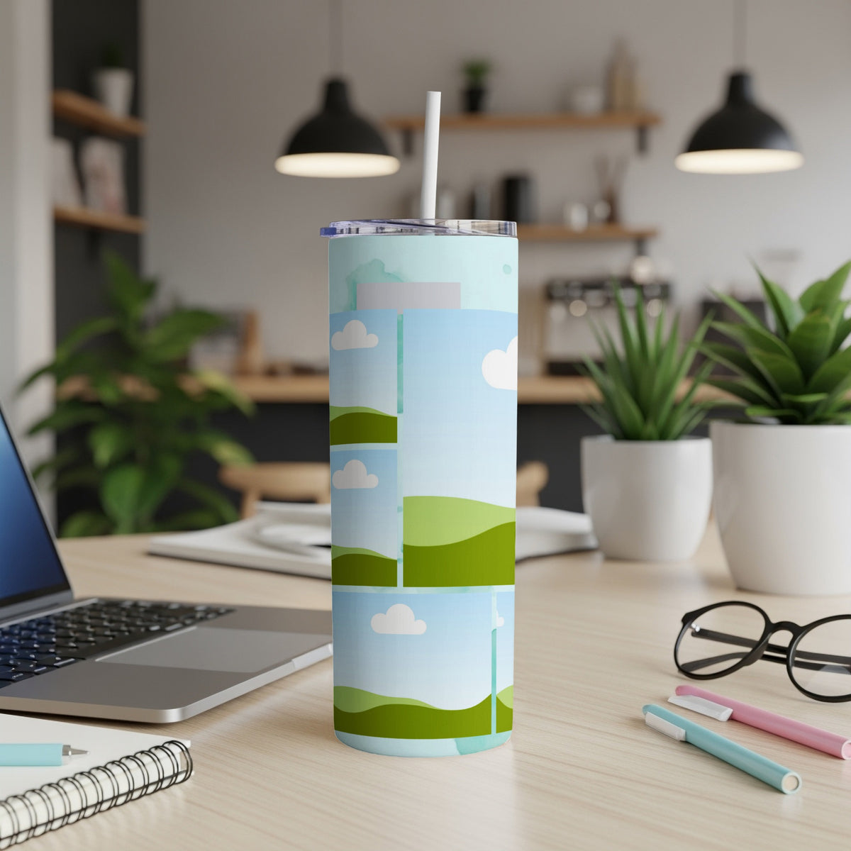 Tumbler with a landscape collage design and a straw.