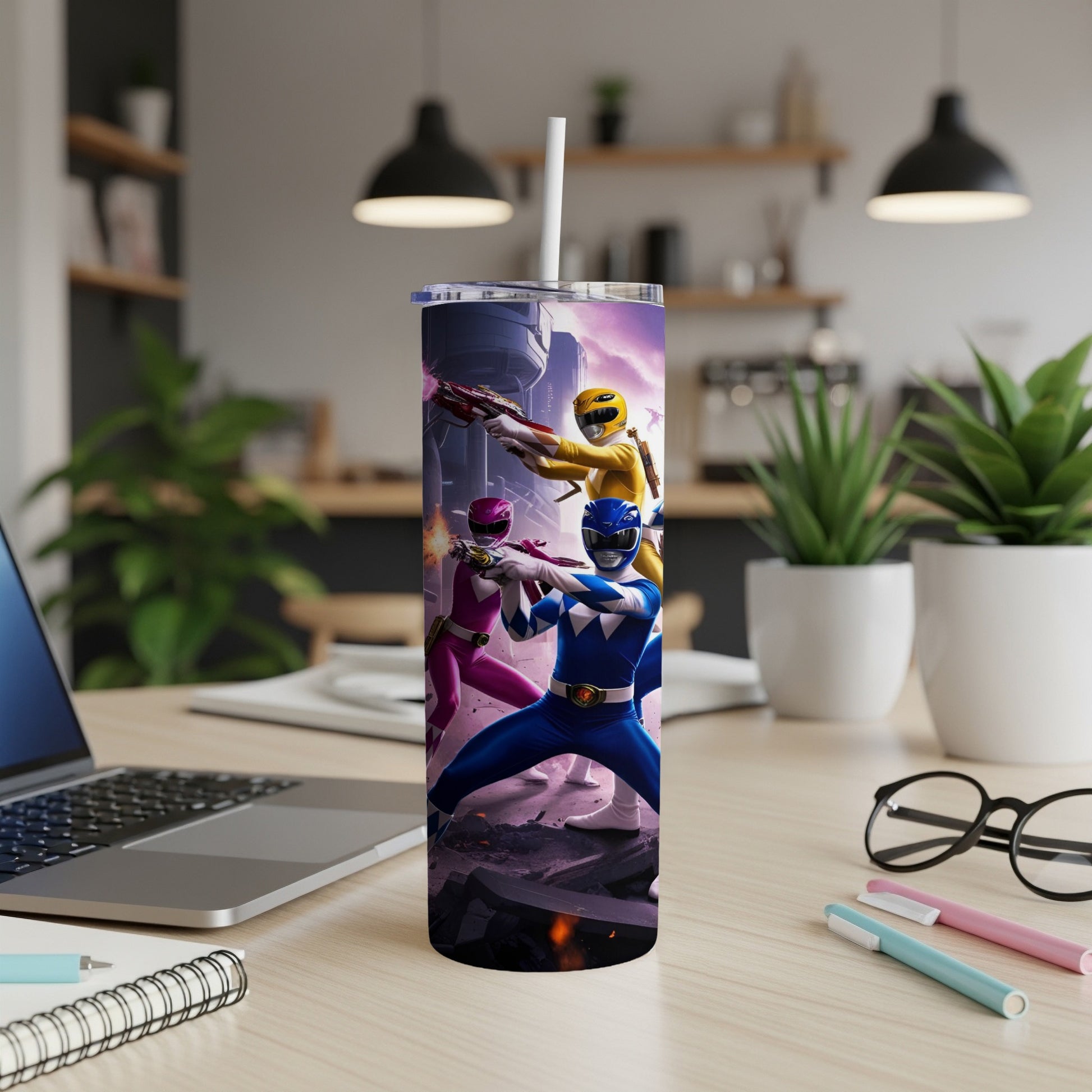Power Rangers characters in action poses on a tumbler, on a desk.