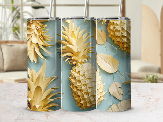 Gold pineapple and palm leaf pattern on a tumbler.