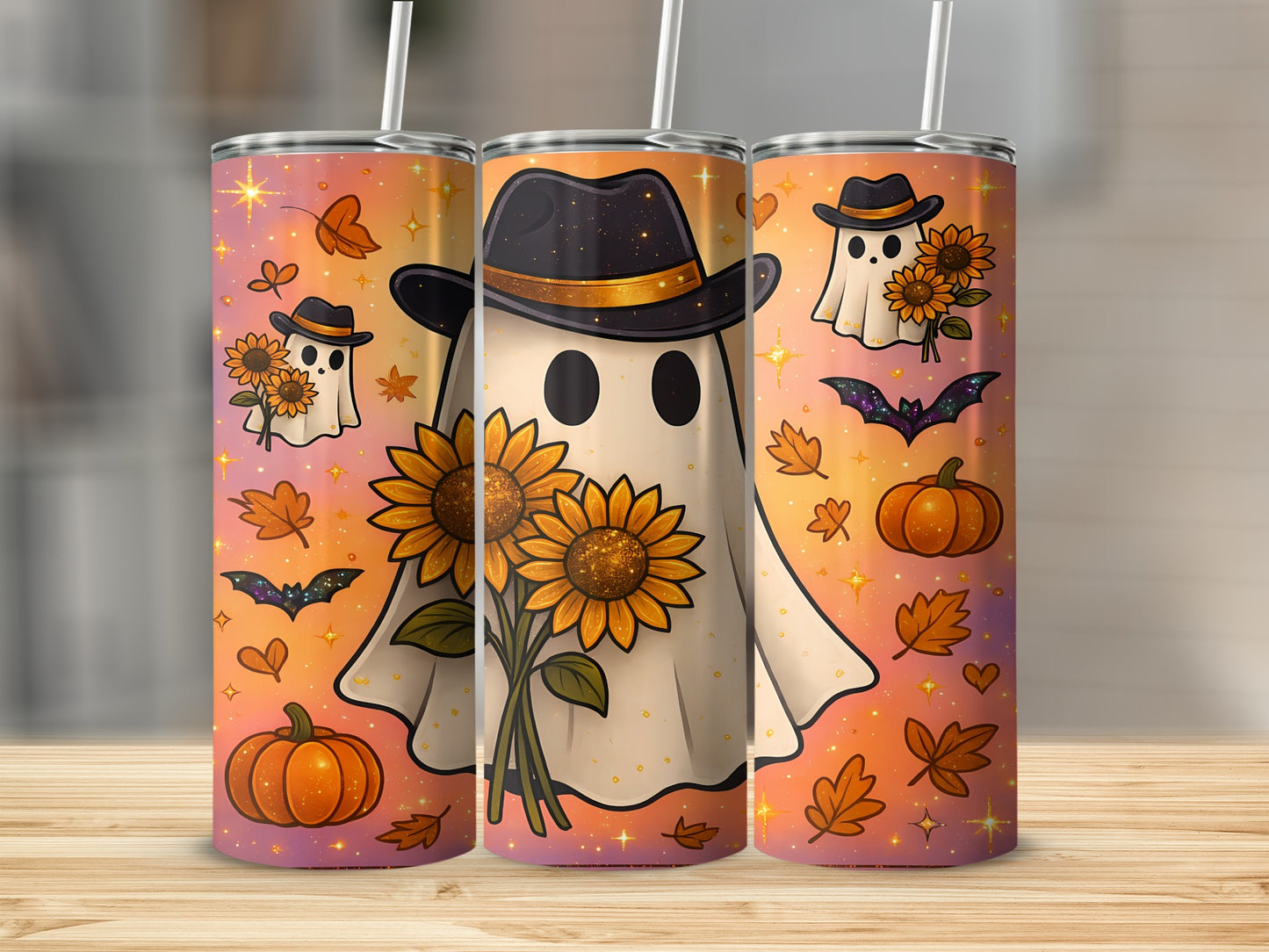 Three tumblers with ghosts, sunflowers, pumpkins, bats, and autumn leaves on an orange gradient background.