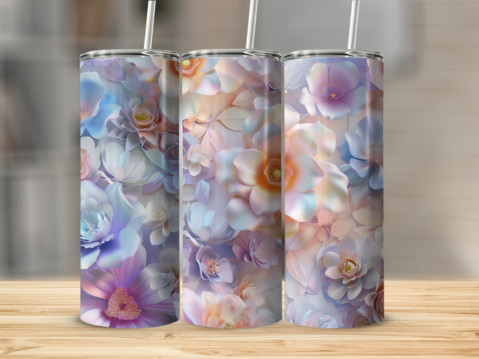 Three tumblers with pastel floral designs and straw tops.