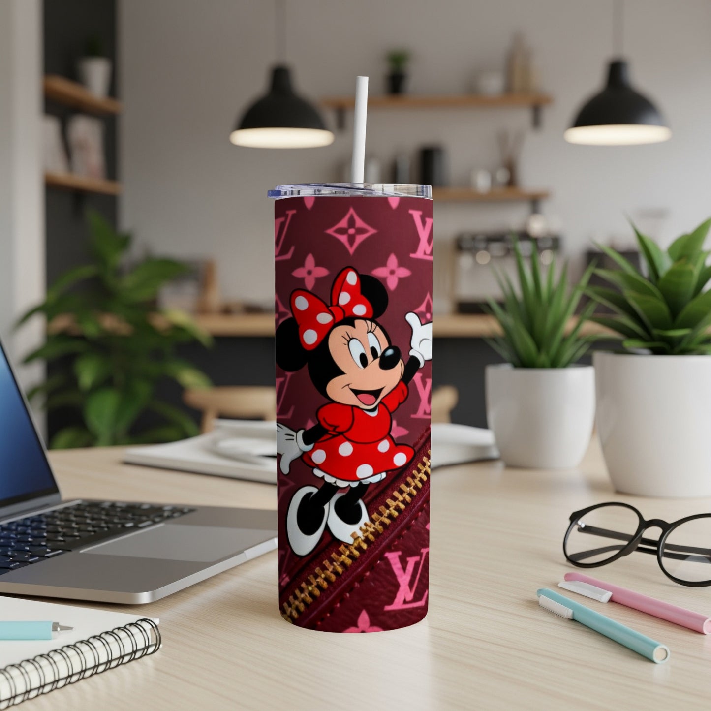 Minnie Mouse on a burgundy tumbler with gold zipper detail and monogram pattern.