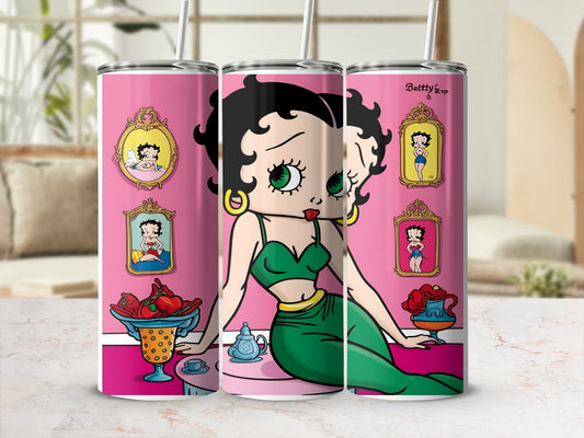 Betty Boop illustration on a pink tumbler with framed images and fruit bowl.