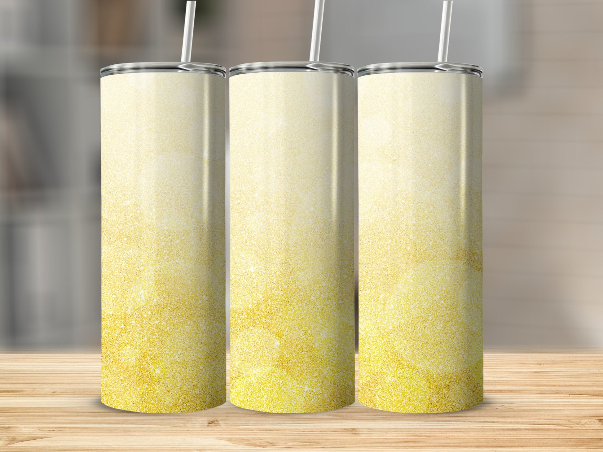 Three tall tumblers with a glittery gold and white ombre design.