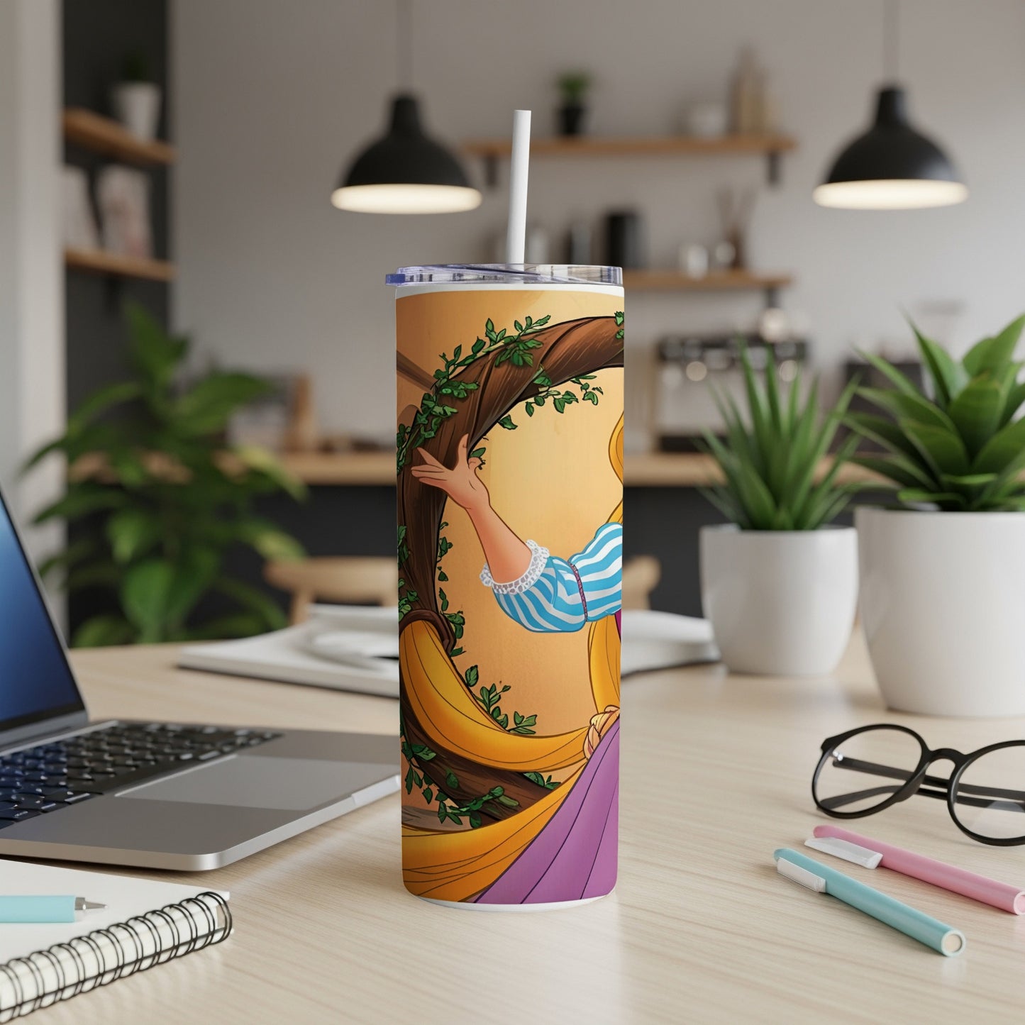 Tangled Rapunzel illustration on a tumbler with straw, placed on a desk.