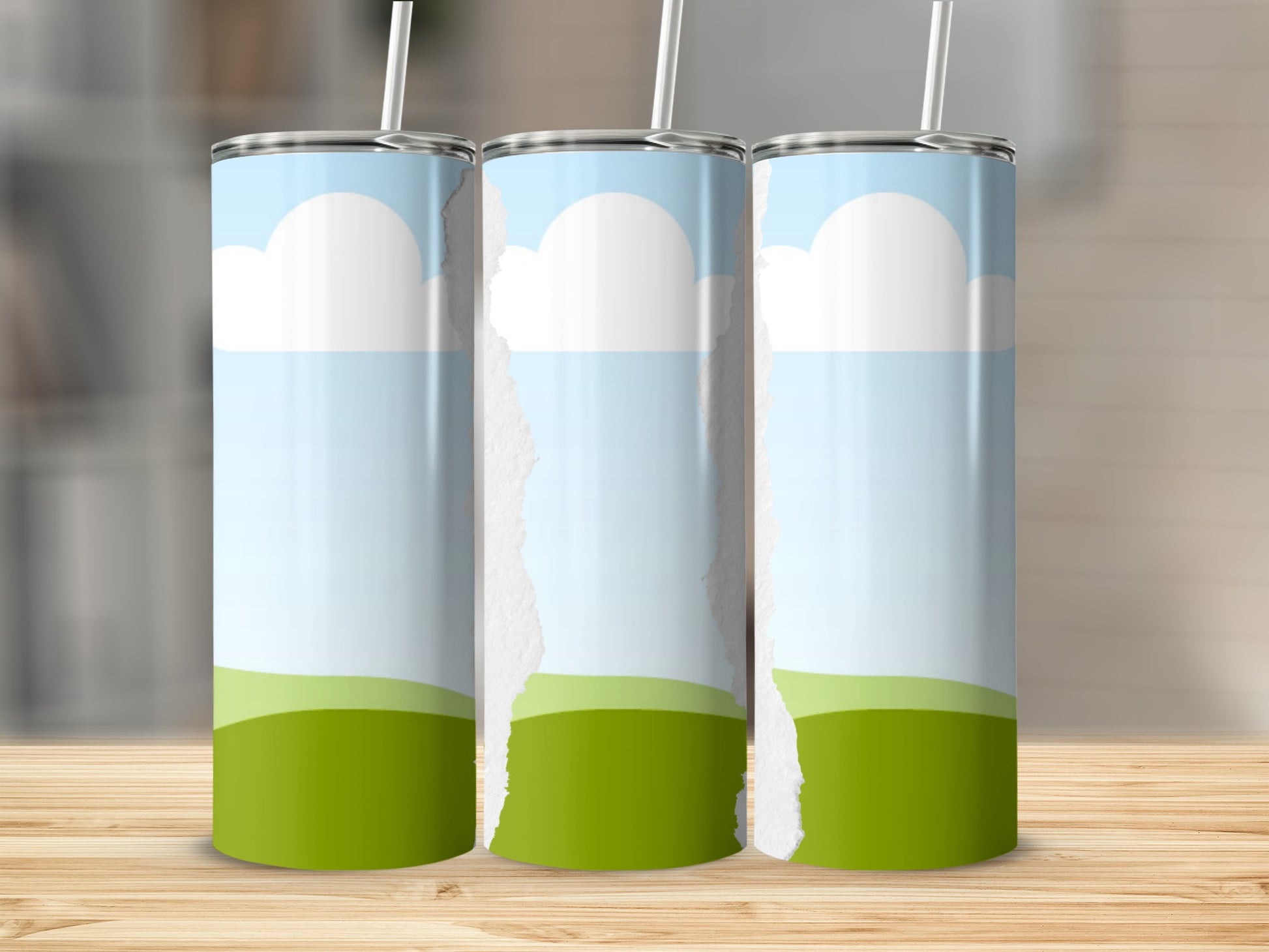 Three tumblers with sky and grass design and torn paper effect.