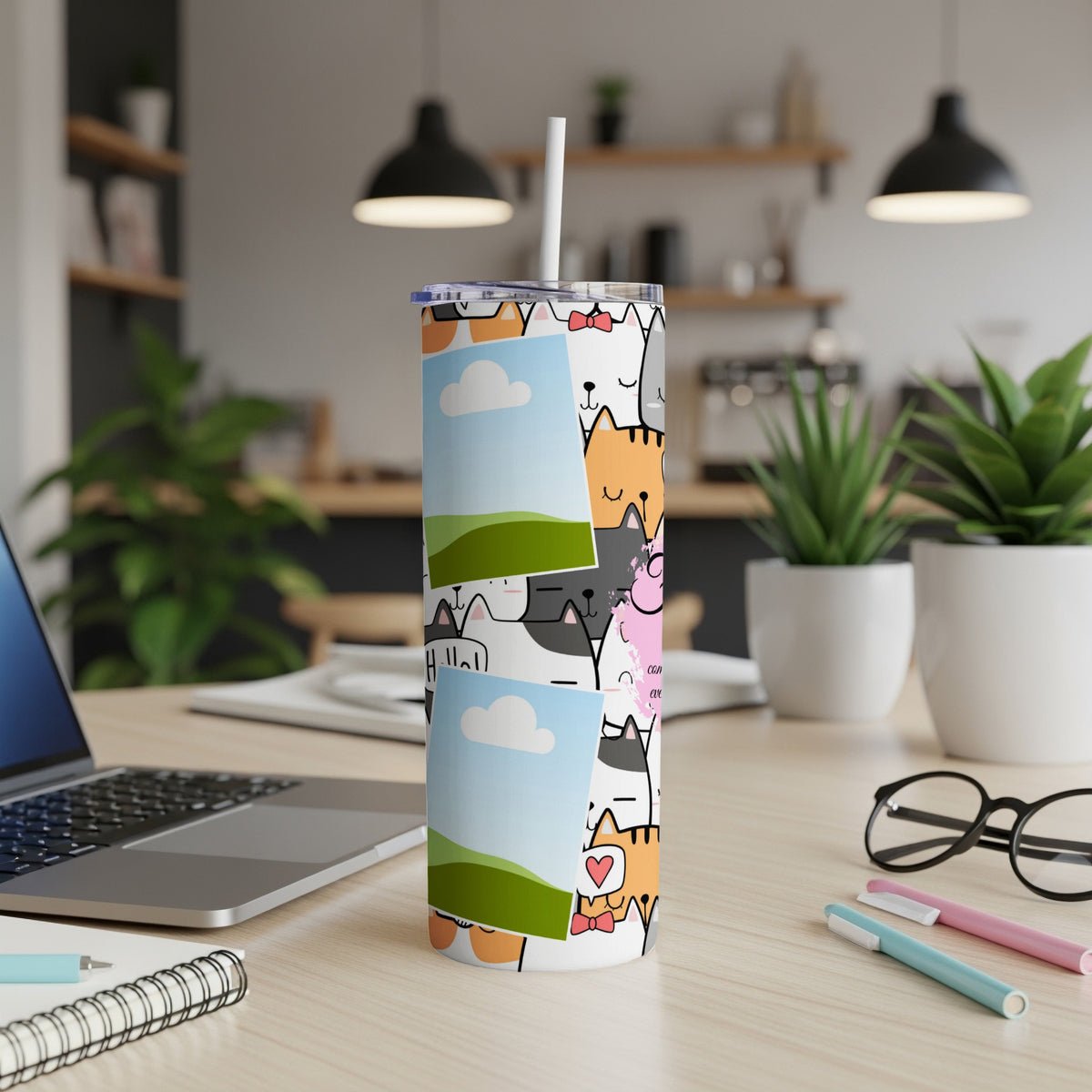 Tumbler with a cartoon cat pattern and two framed photos.