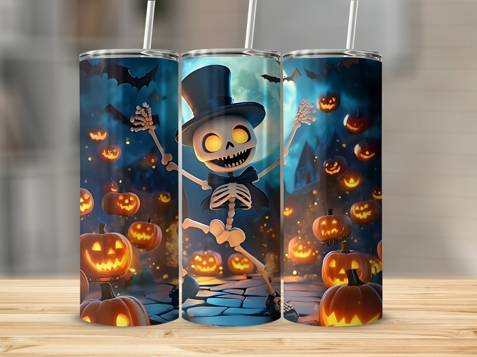 Three tumblers with a Halloween design featuring a dancing skeleton, pumpkins, and bats.