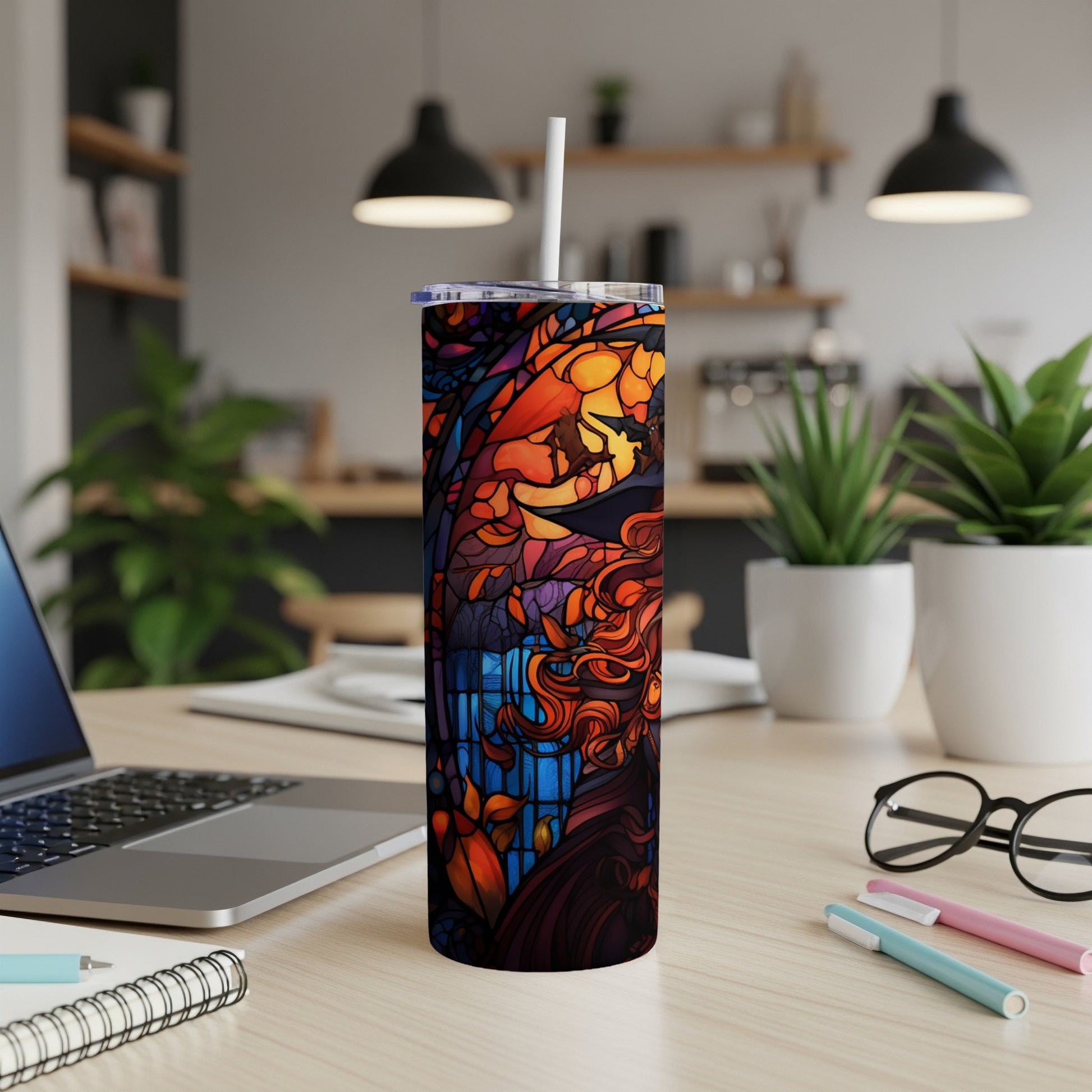 Stained glass design tumbler with a woman's face and flowing hair.